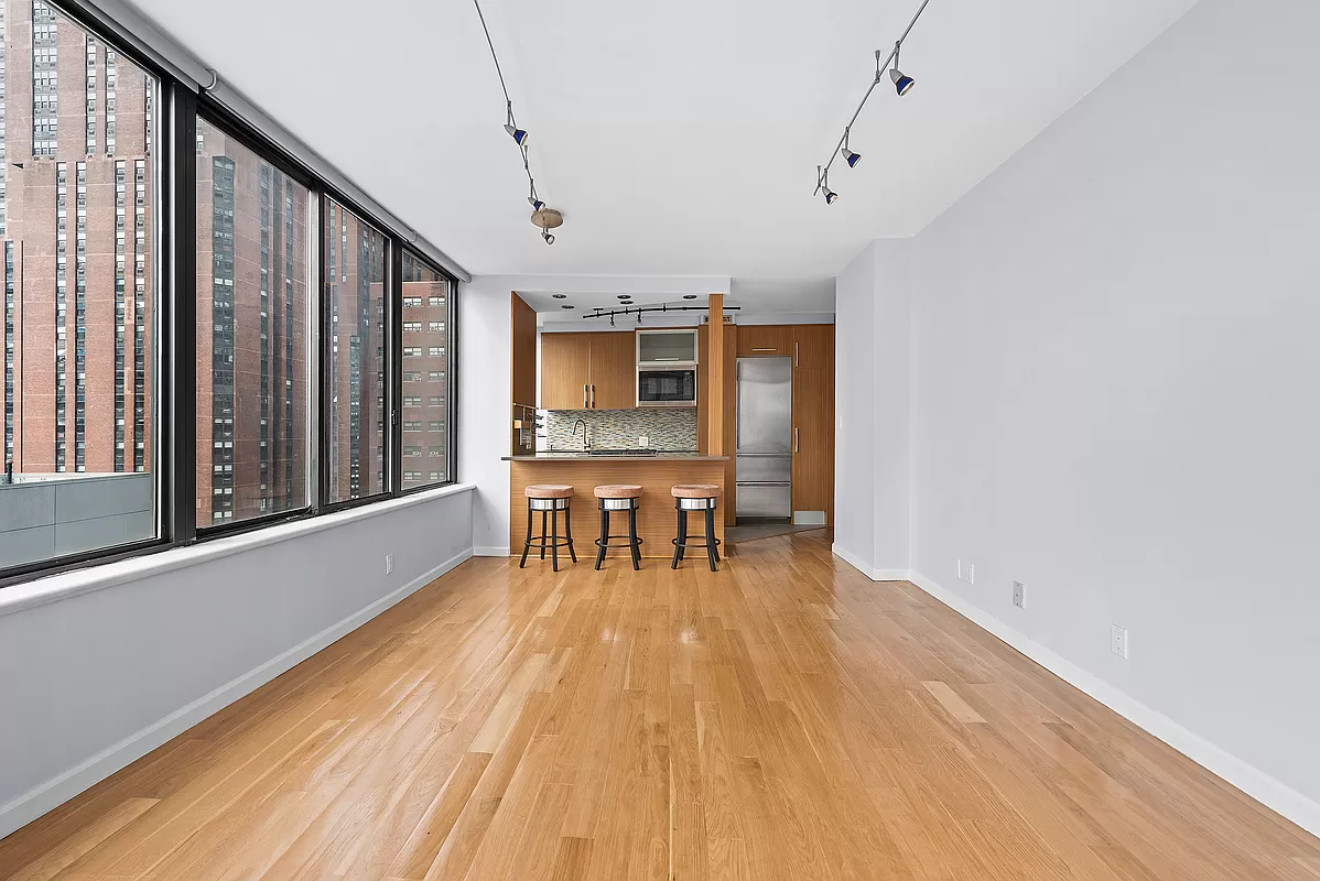 300 East 93rd Street, Unit 14F Manhattan, NY 10128 - Photo 4 of 14 a view of a dining room with furniture window and wooden floor