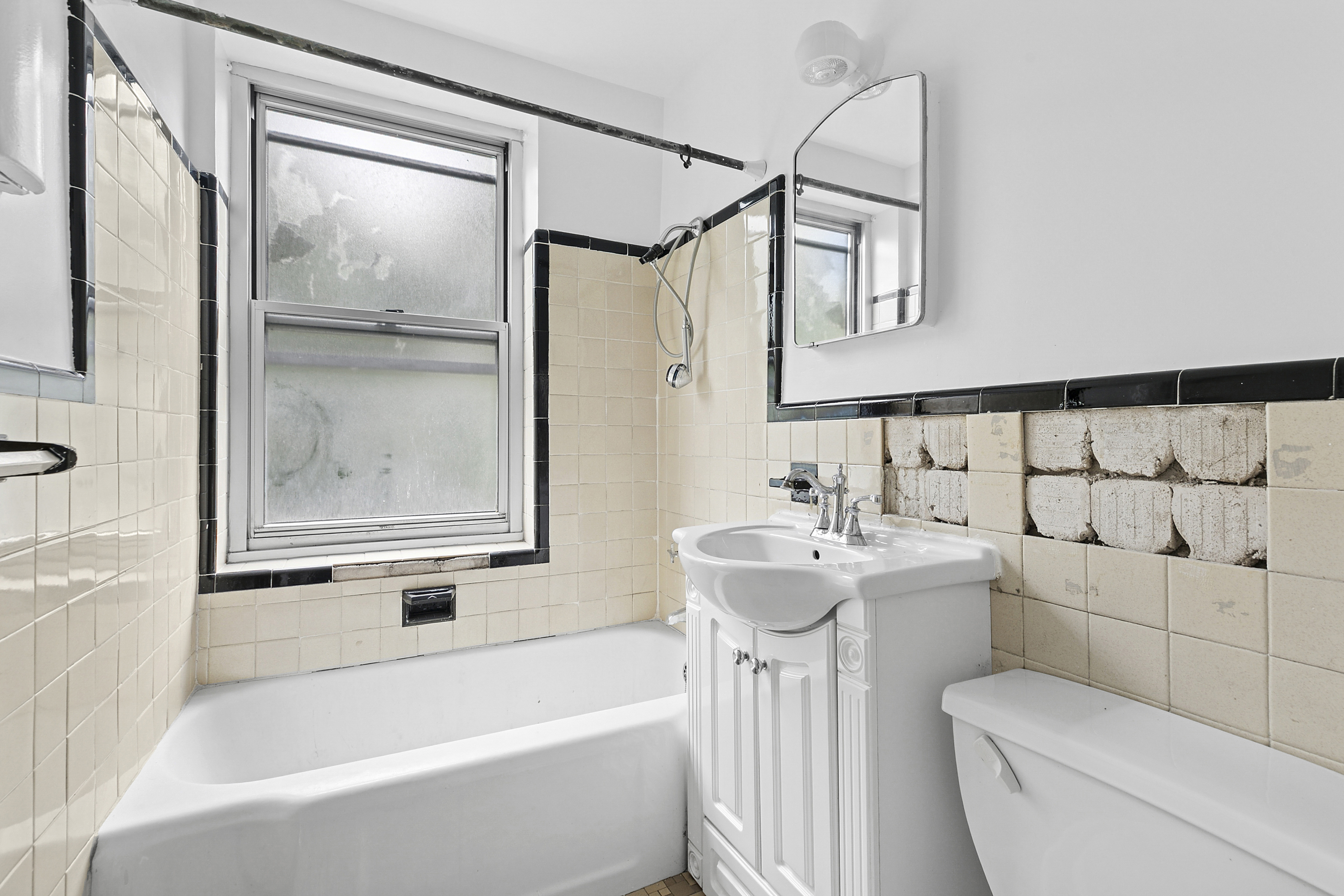 500 Grand Street, Unit C1D Manhattan, NY 10002 - Photo 7 of 8 a bathroom with a sink a toilet and shower