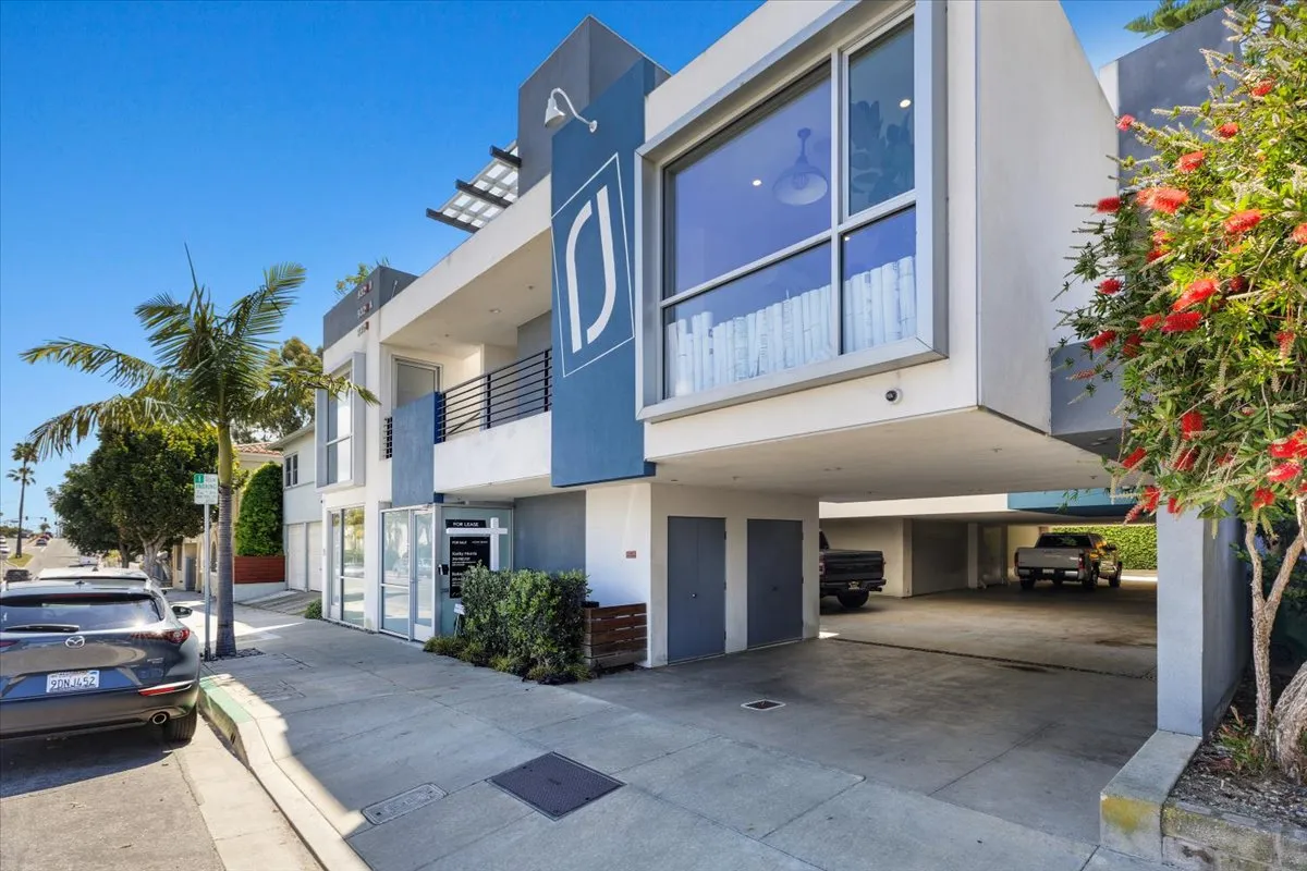a view of a house with a yard and potted plants