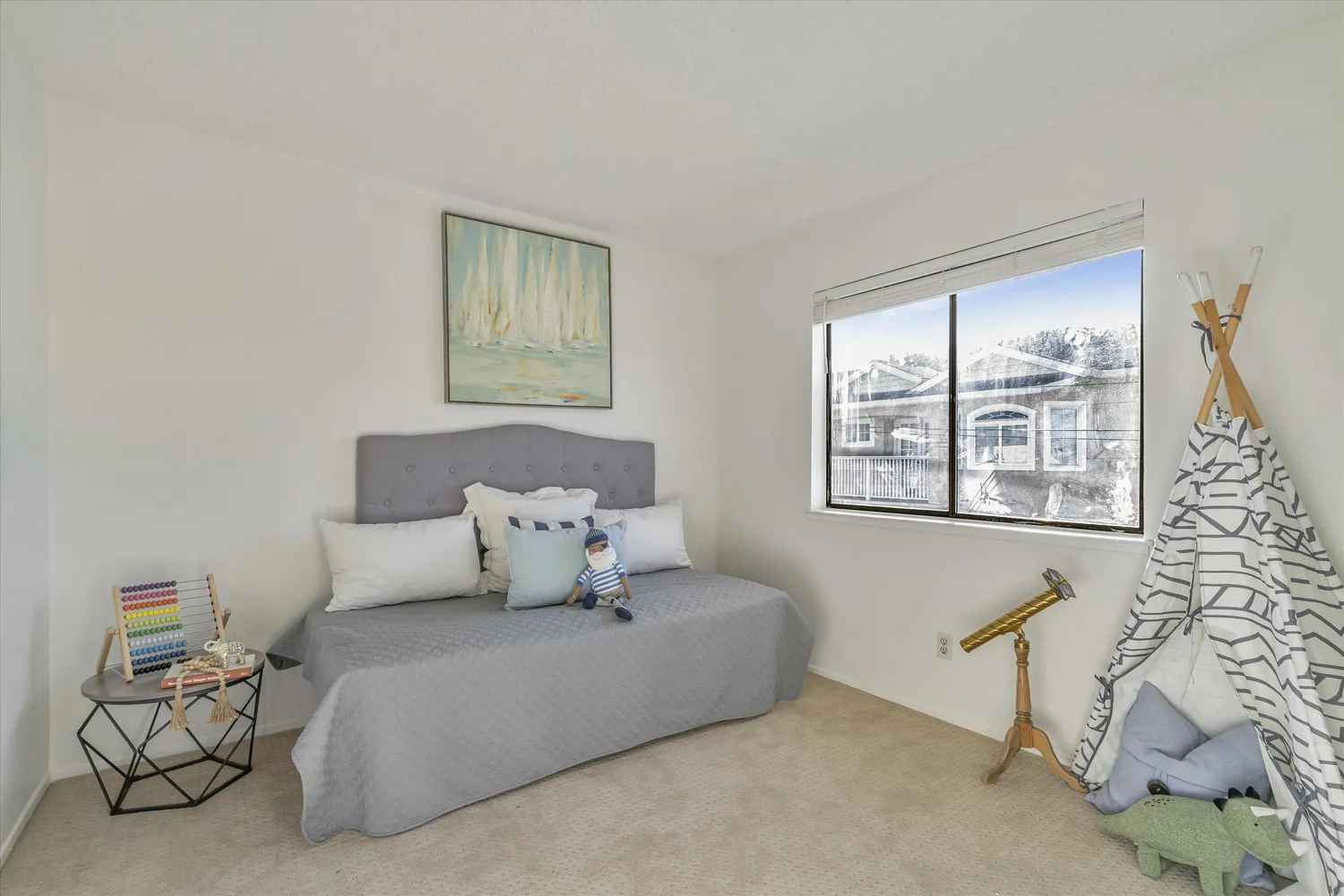 a bed sitting in a bedroom next to a window
