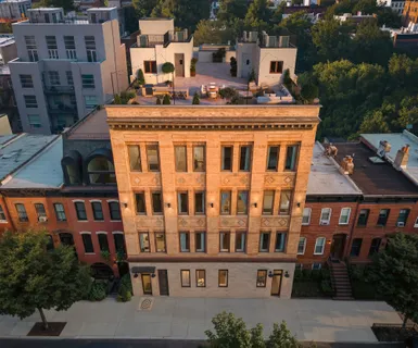 a front view of a building with windows and yard