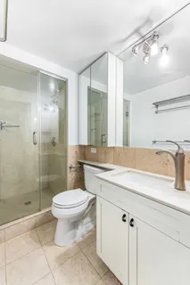 a bathroom with a sink toilet and shower