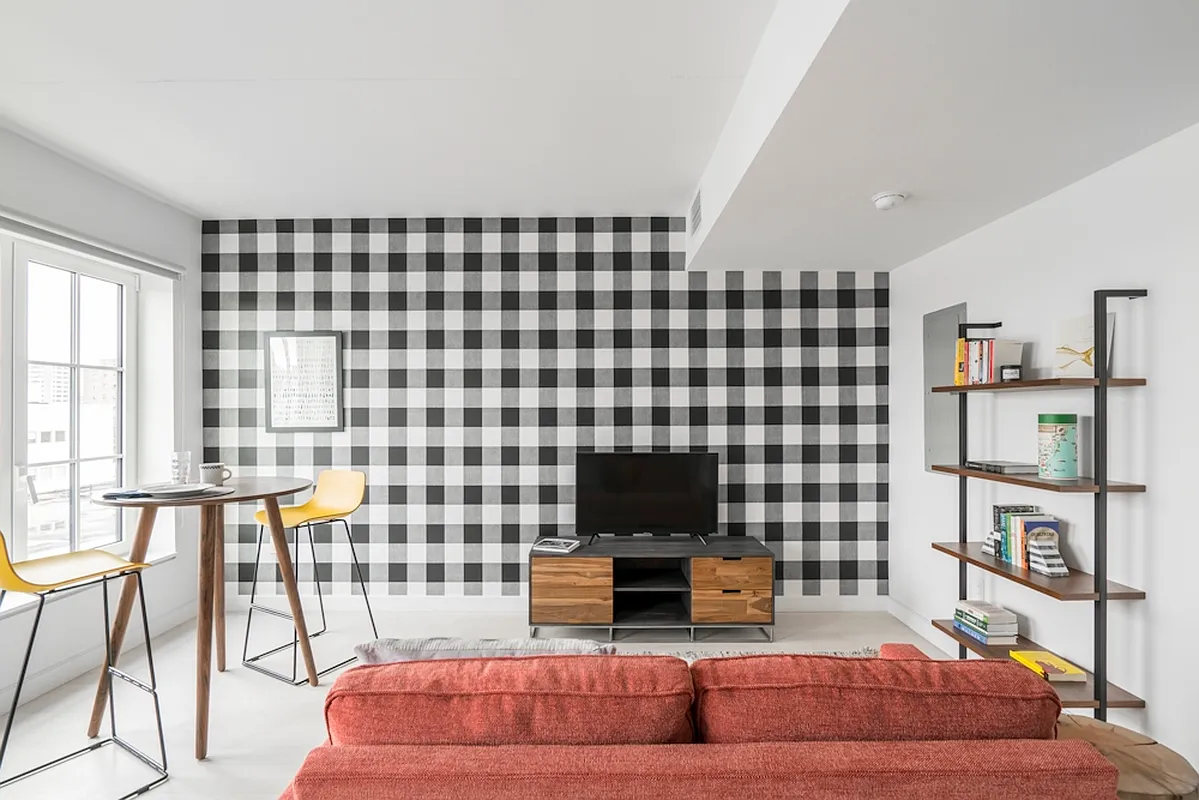 350 Clarkson Avenue, Unit 723 Brooklyn, NY 11226 - Photo 3 of 24 a living room with furniture a flat screen tv and a floor to ceiling window