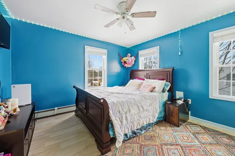 a bedroom with a bed and a chandelier