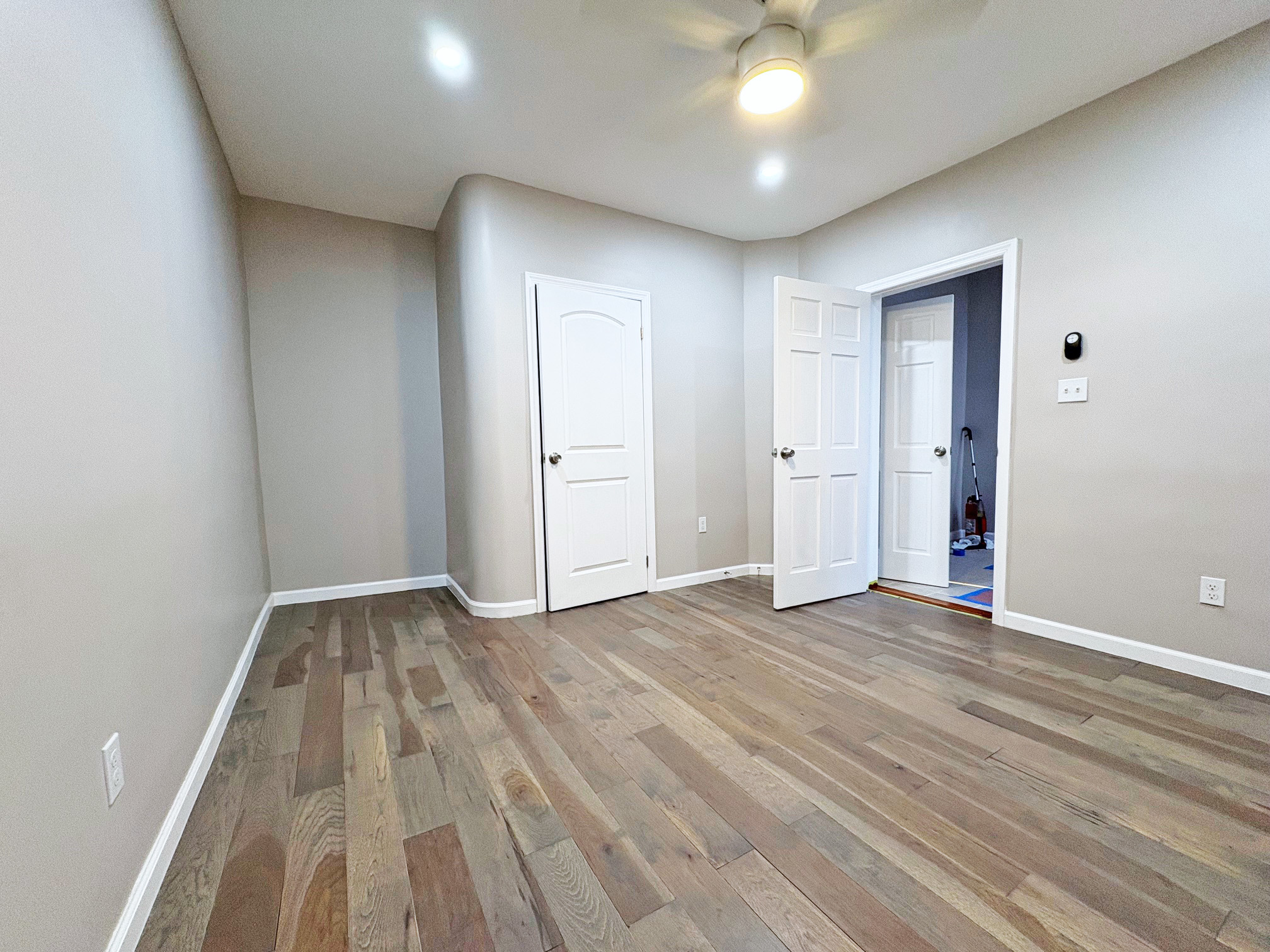 179 Covert Street, Unit 3 Brooklyn, NY 11207 - Photo 7 of 14 an empty room with wooden floor and windows