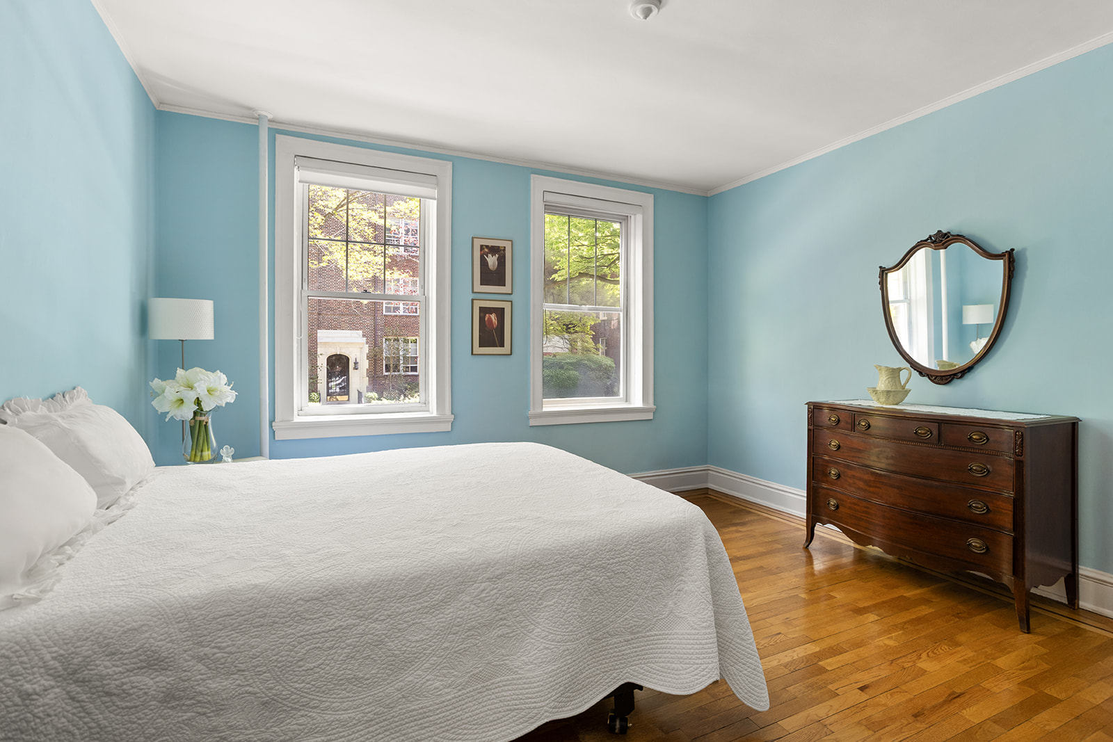34-28 80th Street, Unit 2 Queens, NY 11372 - Photo 8 of 12 a bedroom with a bed mirror and a window