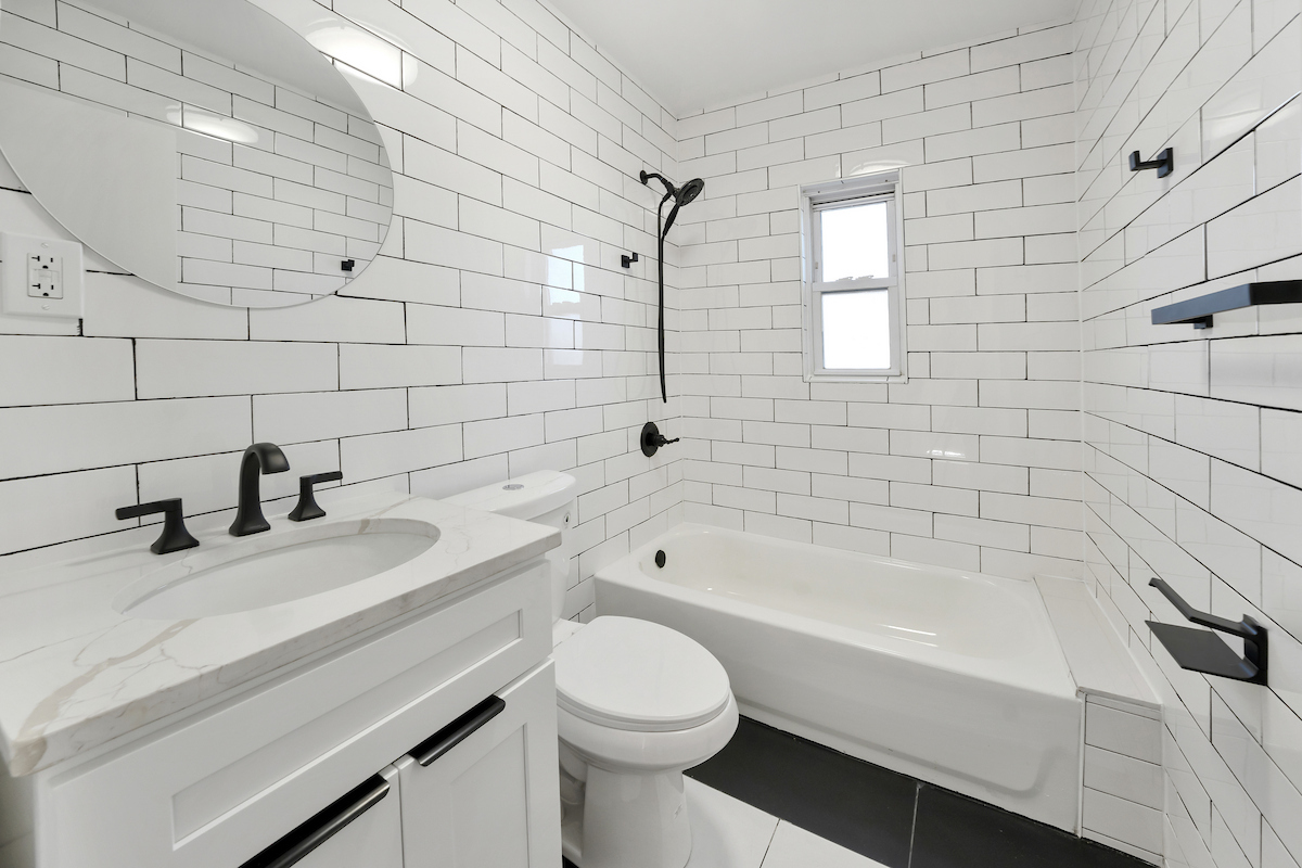 82-56 Eliot Avenue Queens, NY 11379 - Photo 5 of 7 a bathroom with a sink a toilet and bathtub