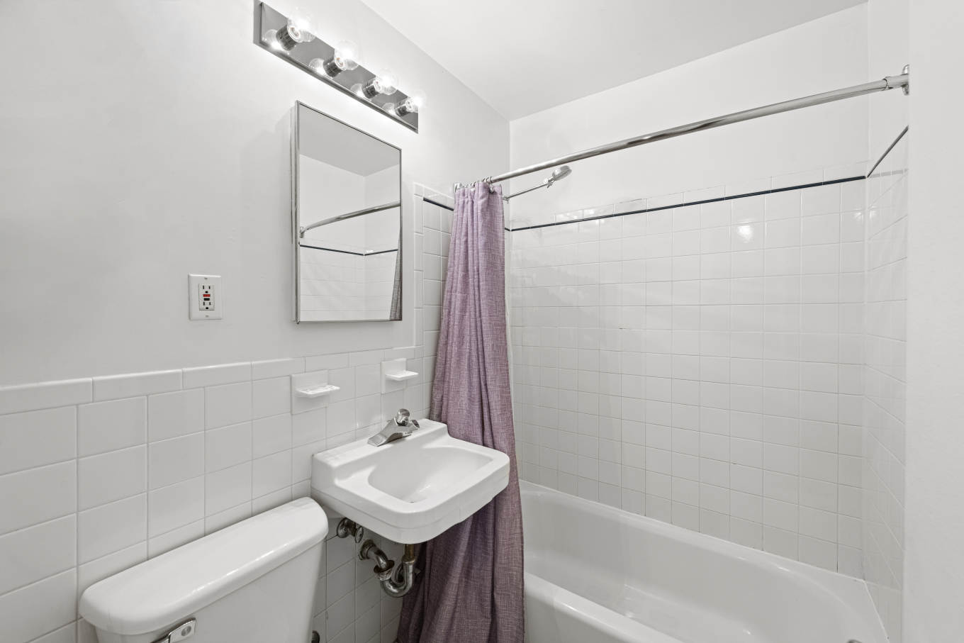 87 St Marks Place, Unit 4E Manhattan, NY 10009 - Photo 4 of 9 a bathroom with a sink a toilet and shower