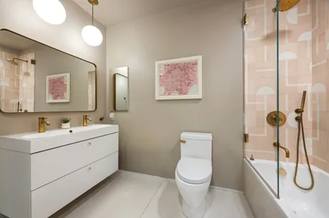 a bathroom with a toilet sink and mirror