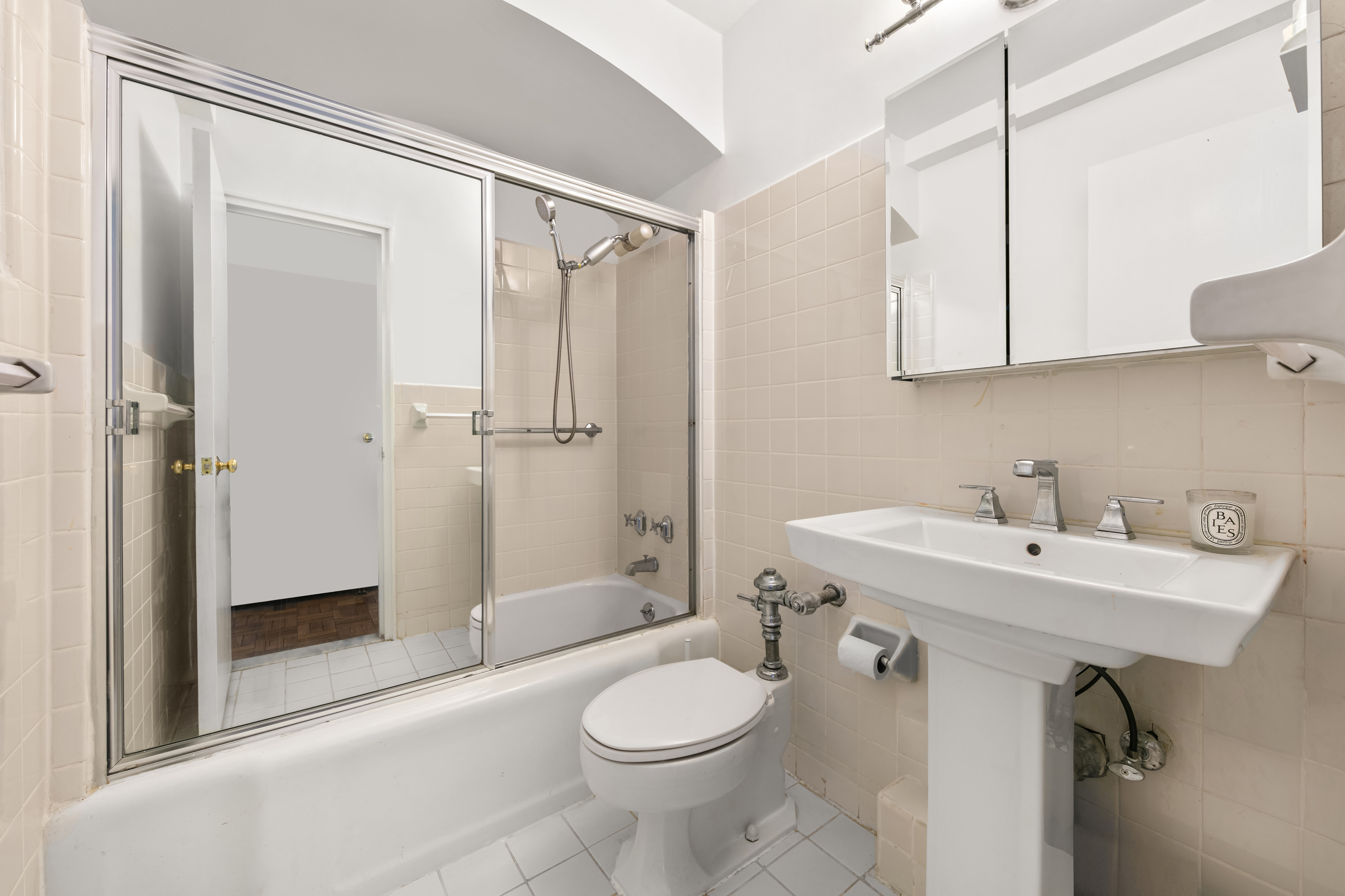 923 5th Avenue, Unit 10F Manhattan, NY 10021 - Photo 15 of 18 a bathroom with a sink toilet and shower