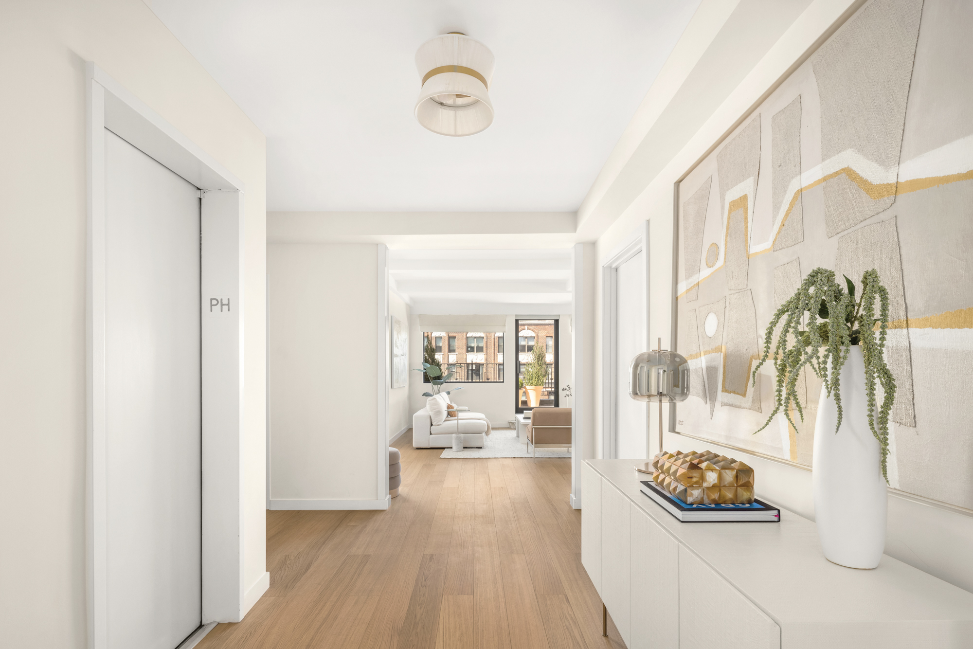 1049 Park Avenue, Unit PH Manhattan, NY 10028 - Photo 9 of 22 a living room with furniture and a large window