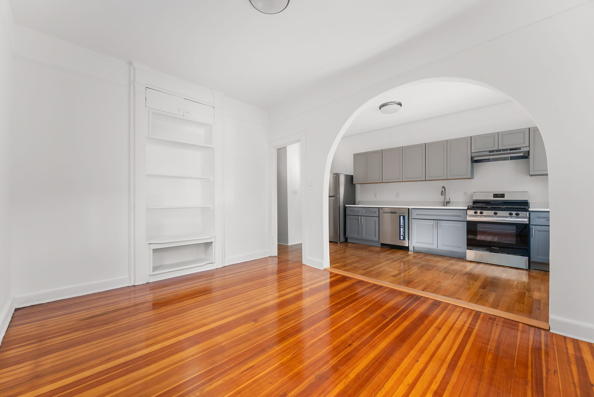 a view of kitchen view wooden floor and electronic appliances