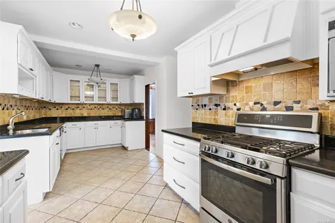 a kitchen with stainless steel appliances a stove sink and cabinets