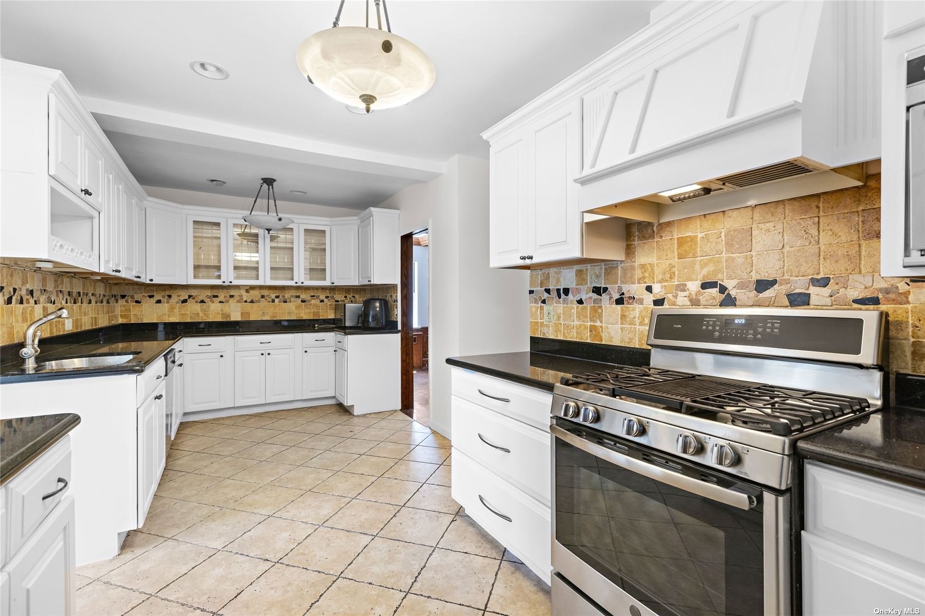 85-23 Edgerton Boulevard Queens, NY 11432 - Photo 10 of 36 a kitchen with stainless steel appliances a stove sink and cabinets