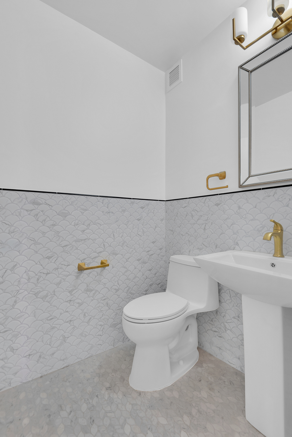 20 West 64th Street, Unit 20K Manhattan, NY 10023 - Photo 11 of 17 a bathroom with a sink a toilet and a mirror