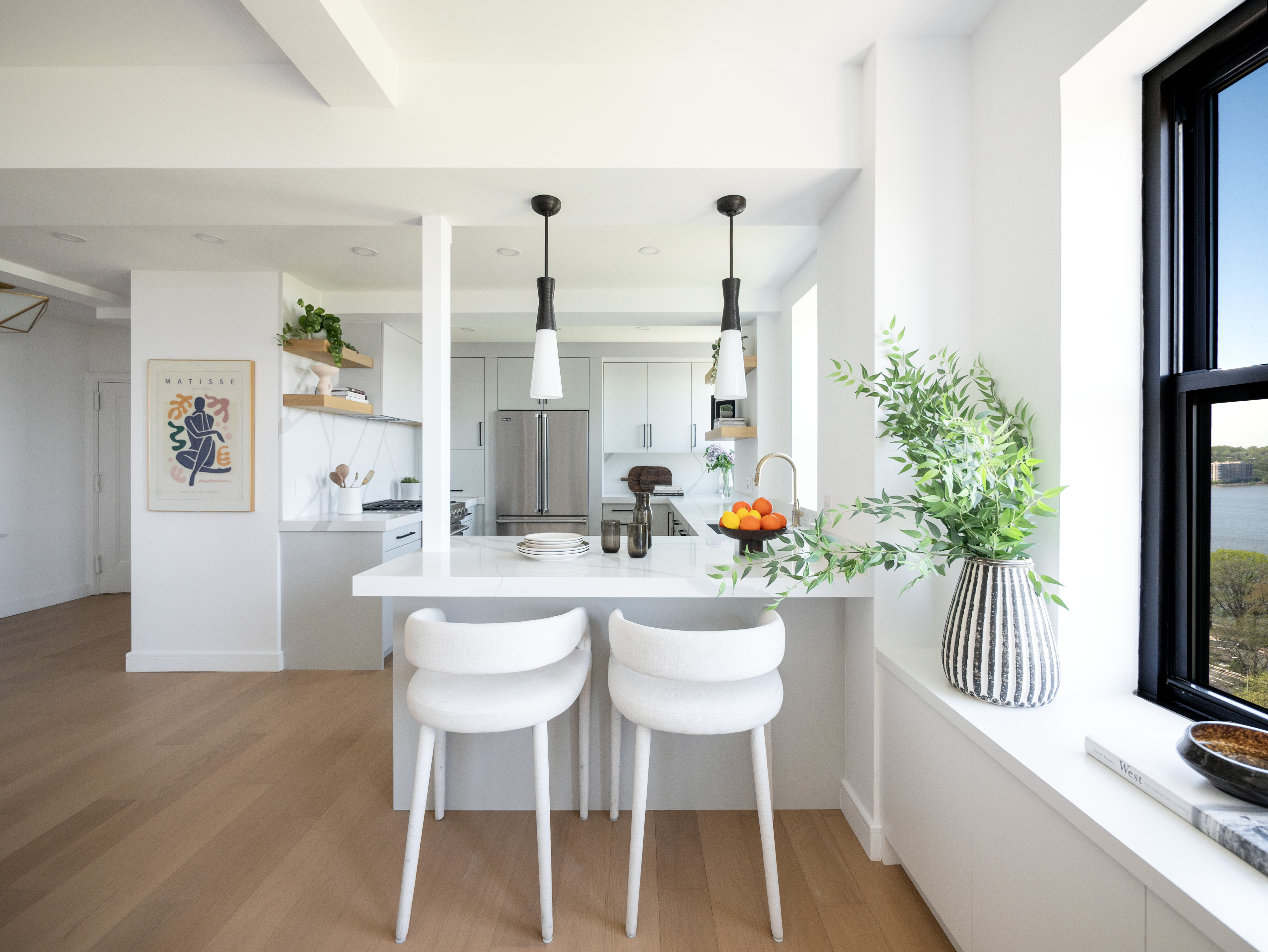 230 Riverside Drive, Unit 14AC Manhattan, NY 10025 - Photo 16 of 30 a dining room with furniture potted plants and wooden floor