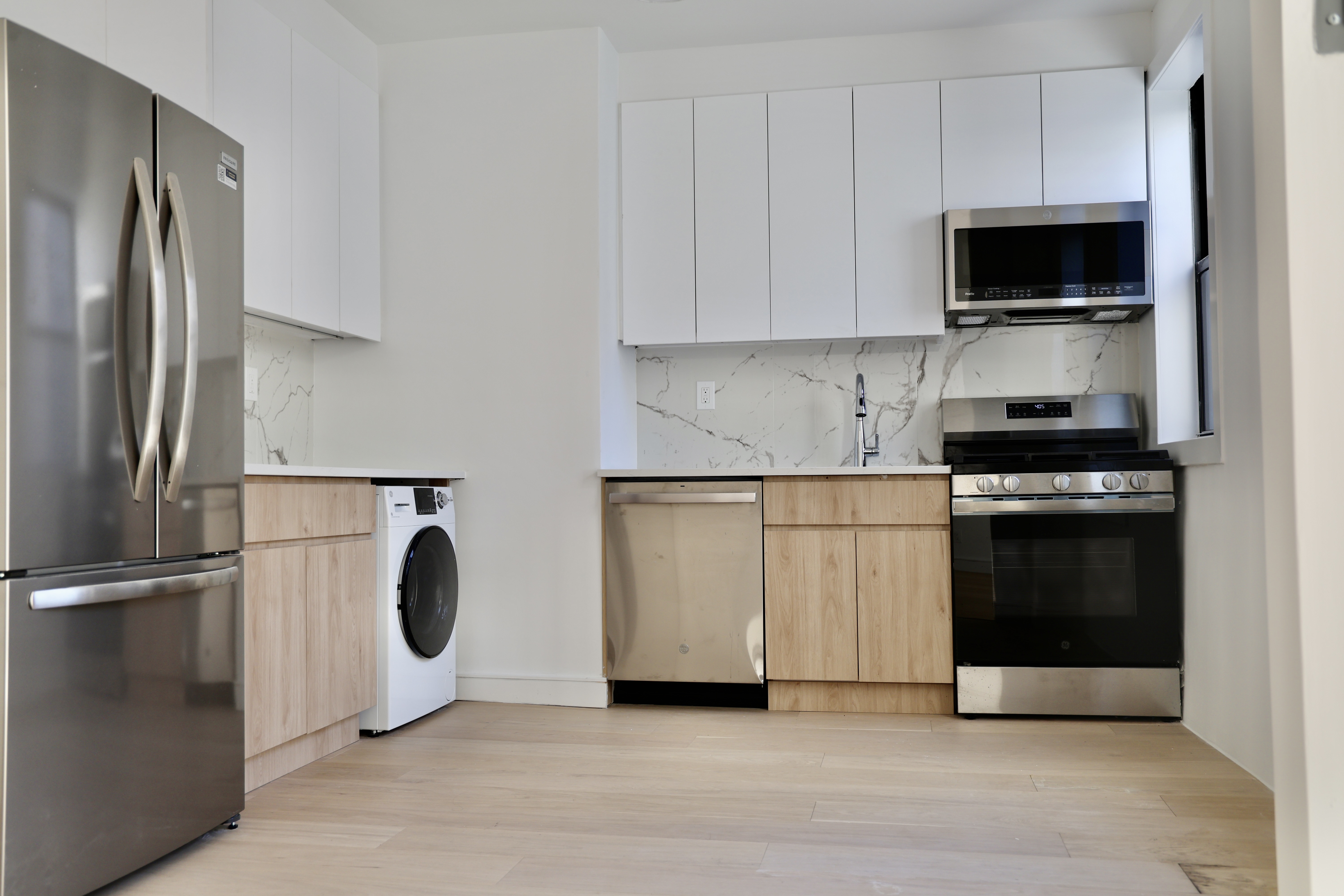 807 Riverside Drive, Unit 6E Manhattan, NY 10032 - Photo 3 of 7 a kitchen with a refrigerator and a stove top oven