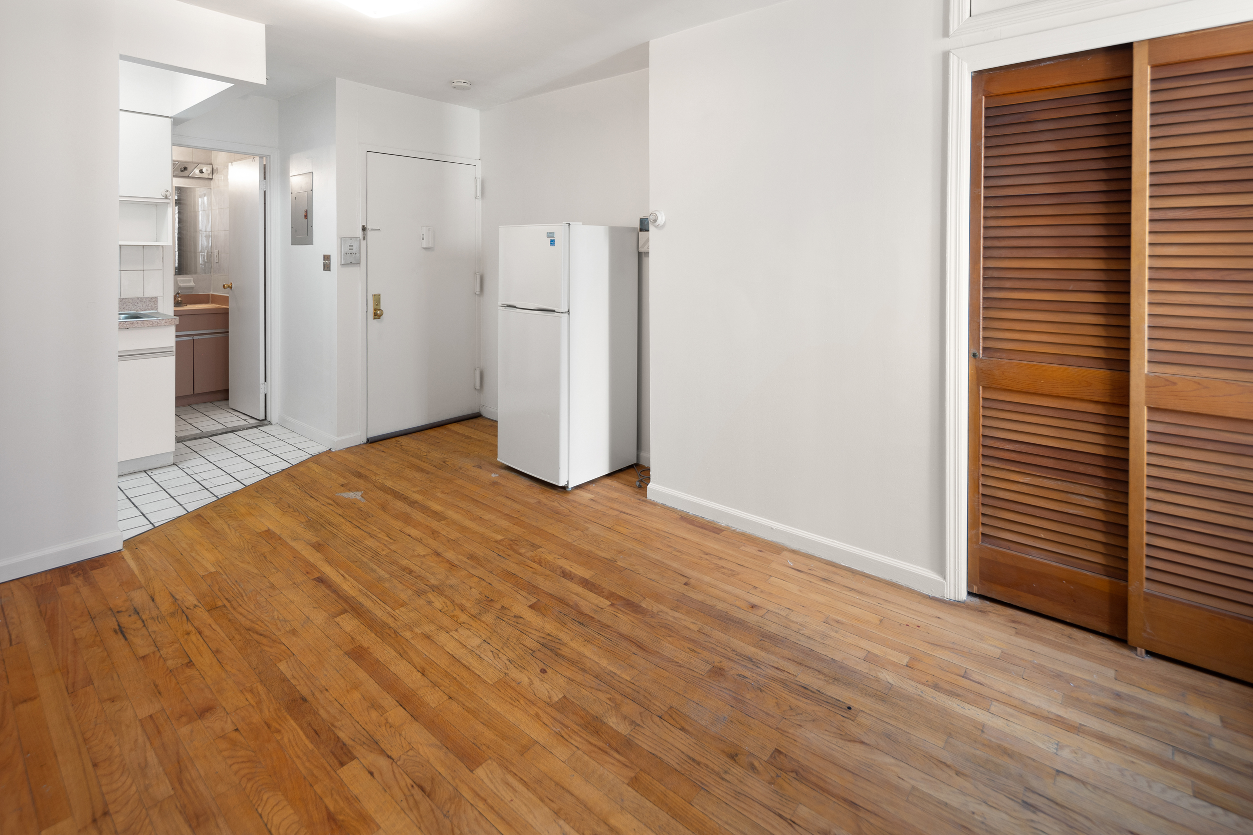 101 Allen Street, Unit 2D Manhattan, NY 10002 - Photo 2 of 4 a view of empty room with wooden floor