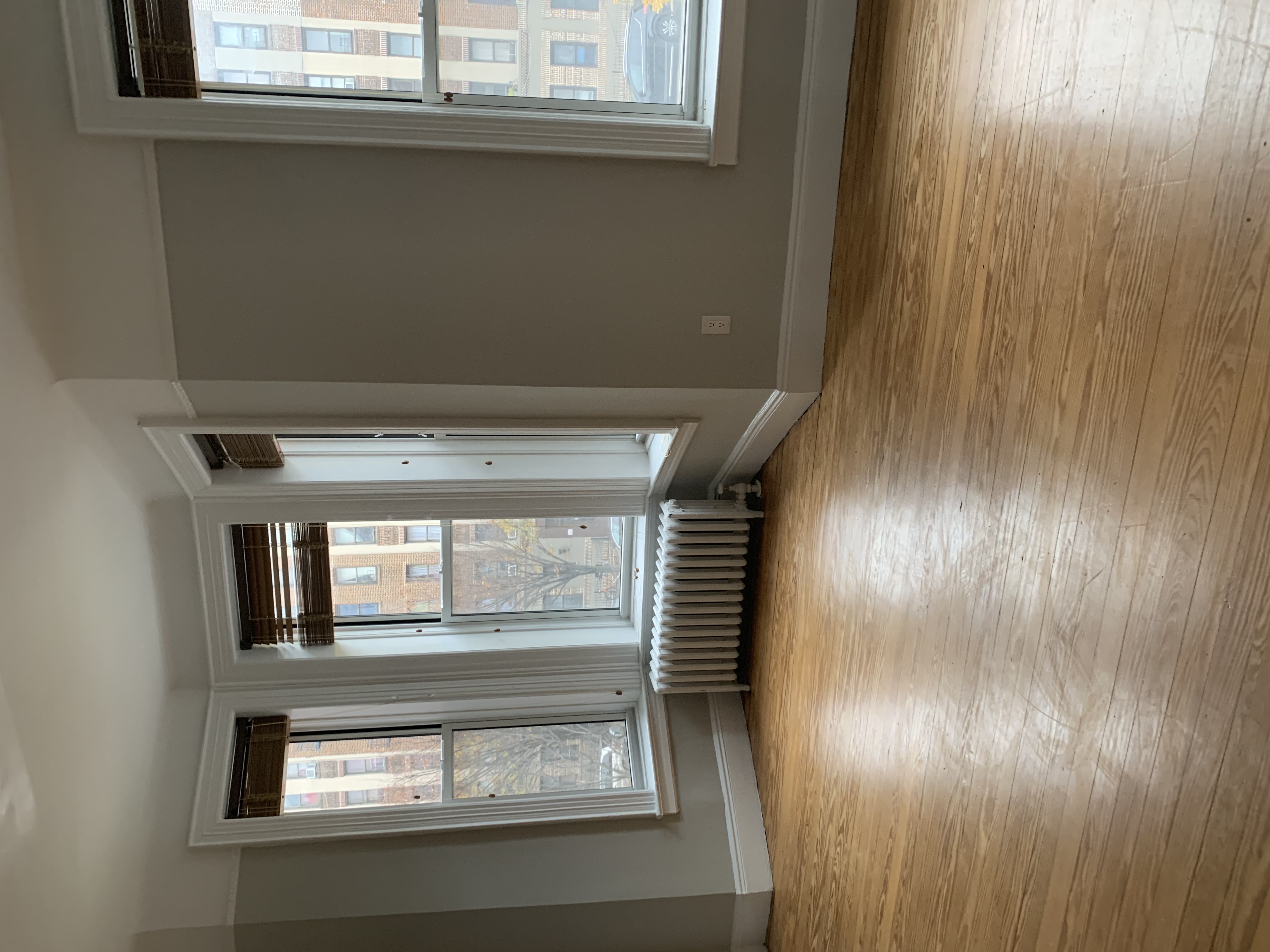 285 Empire Boulevard Brooklyn, NY 11225 - Photo 4 of 7 a view of an empty room with wooden floor and a window