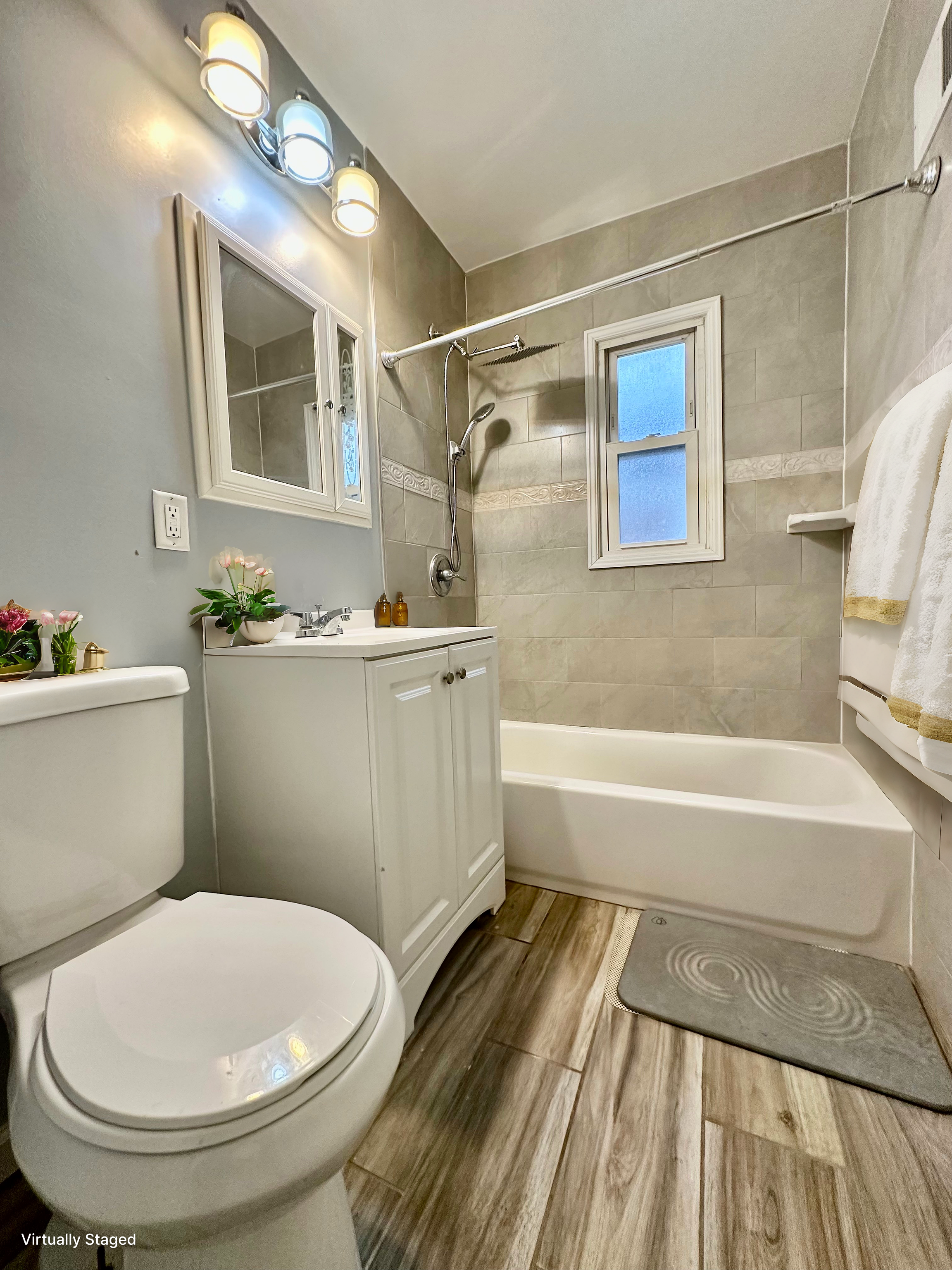 75-66 197th Street Queens, NY 11366 - Photo 14 of 14 a bathroom with a sink a toilet a mirror and shower