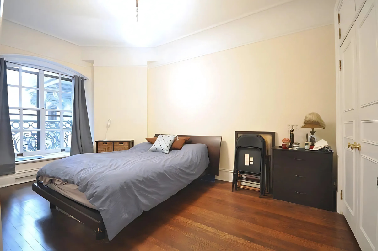 2109 Broadway, Unit 531 Manhattan, NY 10023 - Photo 3 of 8 a bedroom with a bed and wooden floor