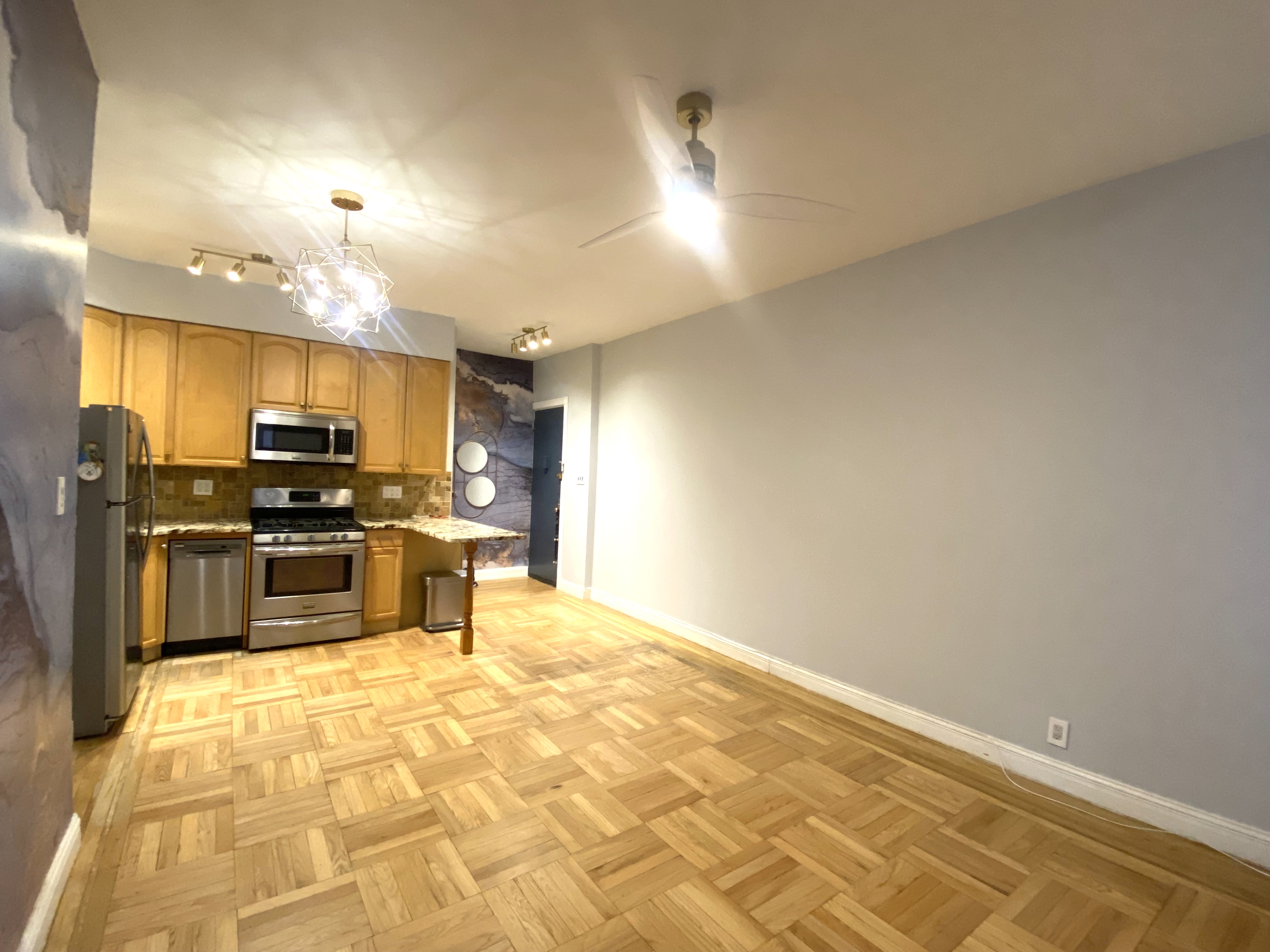 7101 Colonial Road, Unit L4G Brooklyn, NY 11209 - Photo 4 of 8 a kitchen with granite countertop a sink cabinets and stainless steel appliances