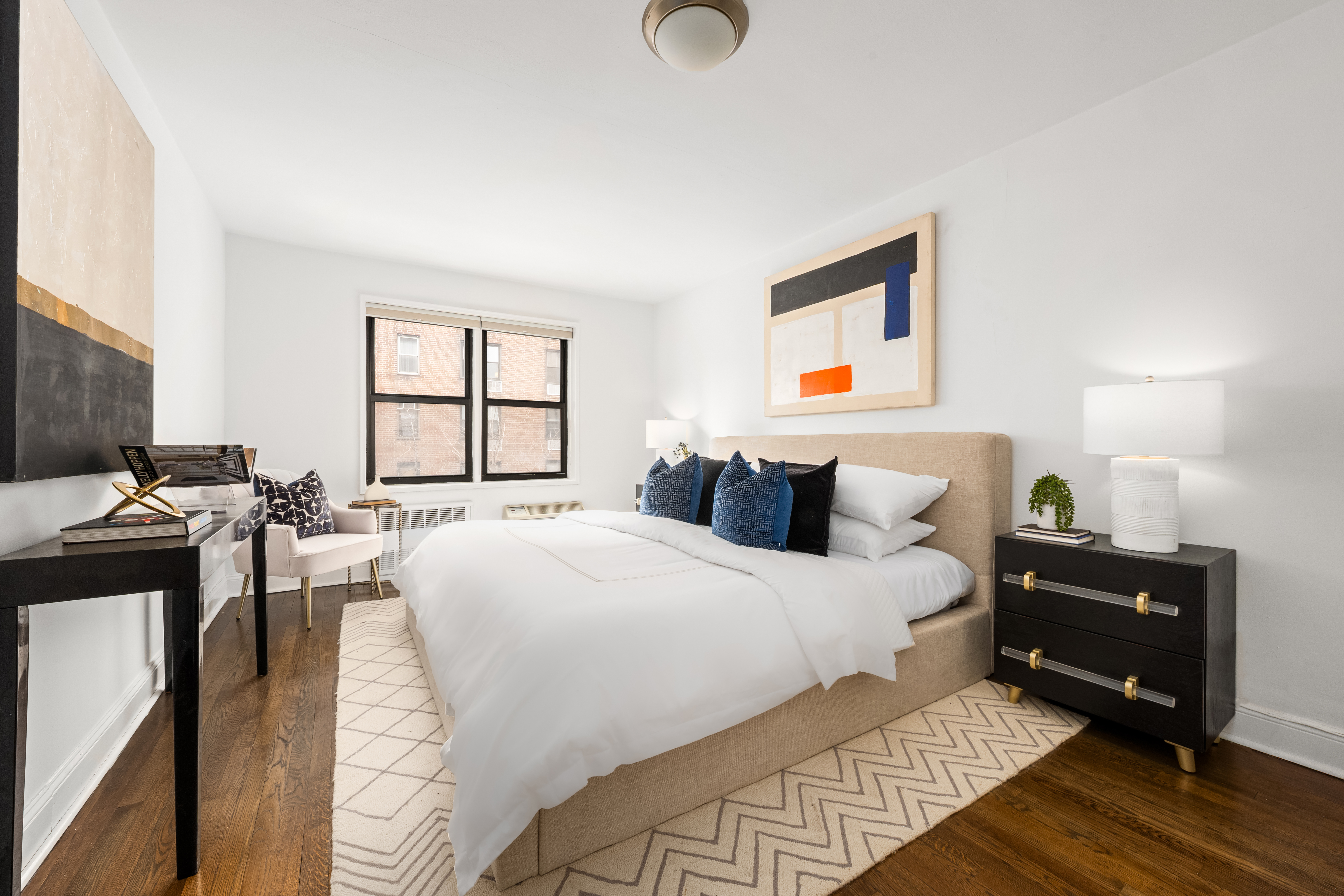 140 7th Avenue, Unit 4M Manhattan, NY 10011 - Photo 5 of 8 a bedroom with a bed and a window