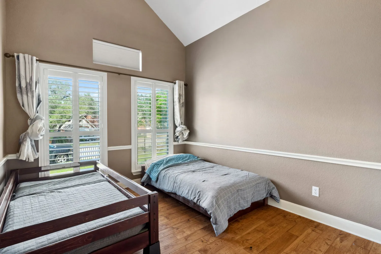 a bedroom with a bed and a window