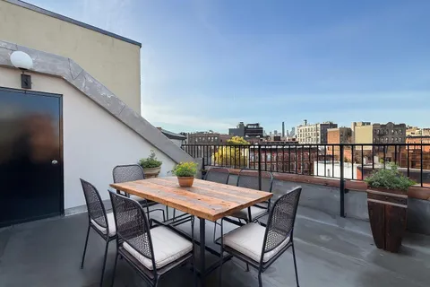 a balcony with furniture and city view