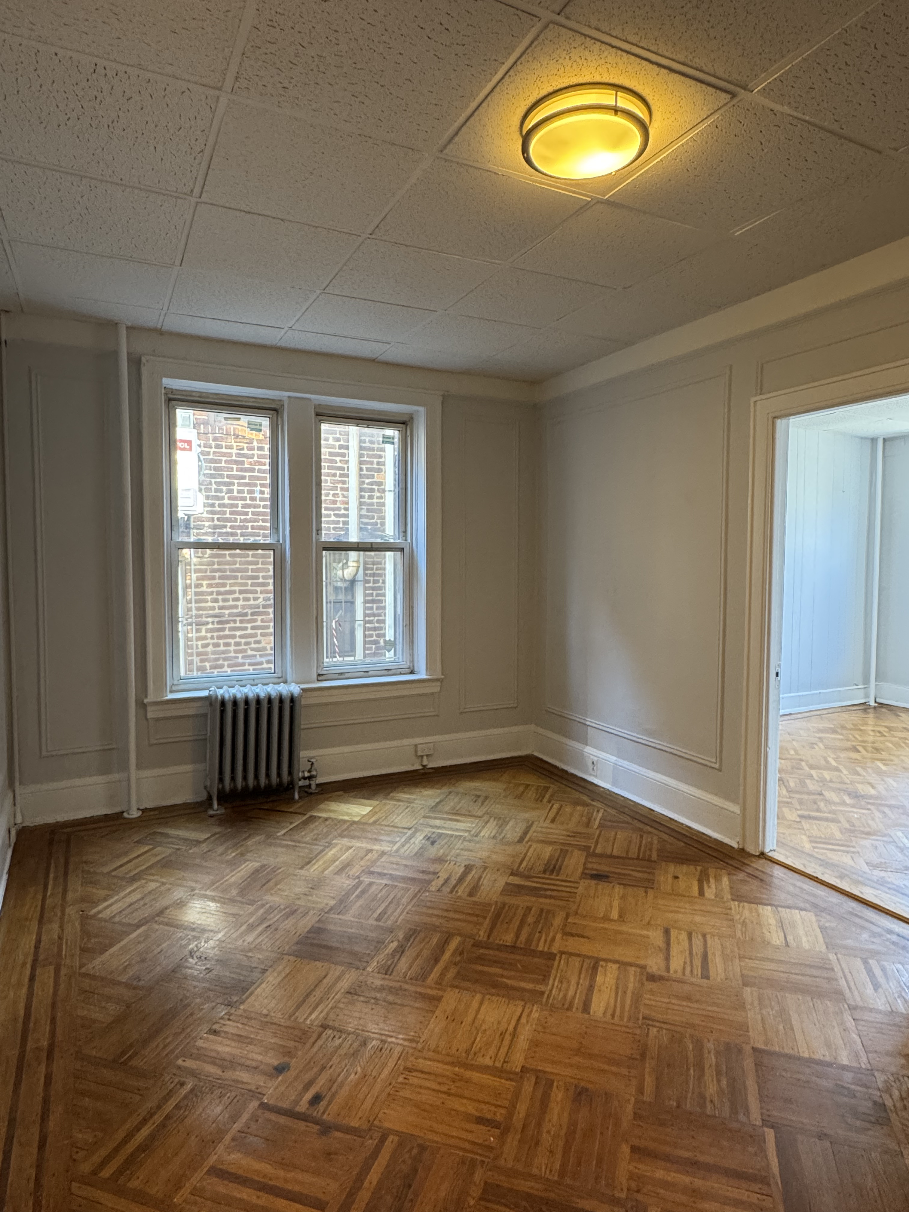 191-13 42nd Avenue, Unit 1F Queens, NY 11358 - Photo 3 of 6 a view of an empty room with a window