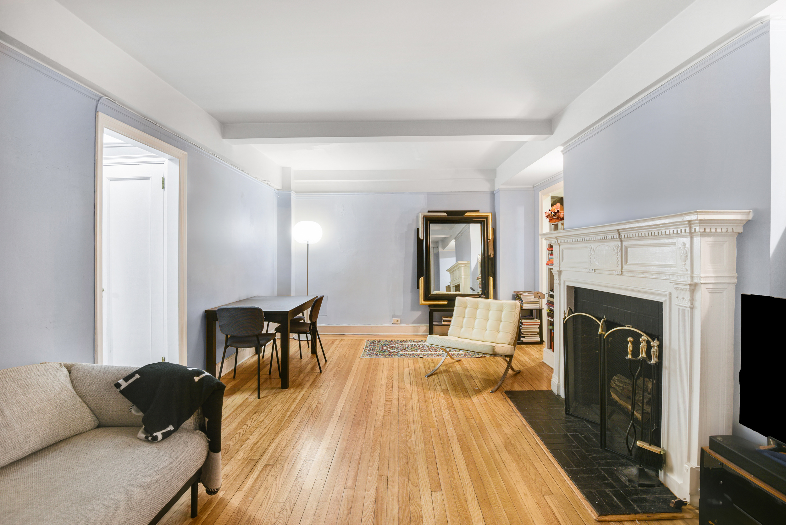205 East 78th Street, Unit 2T Manhattan, NY 10075 - Photo 3 of 10 a living room with furniture and a fireplace