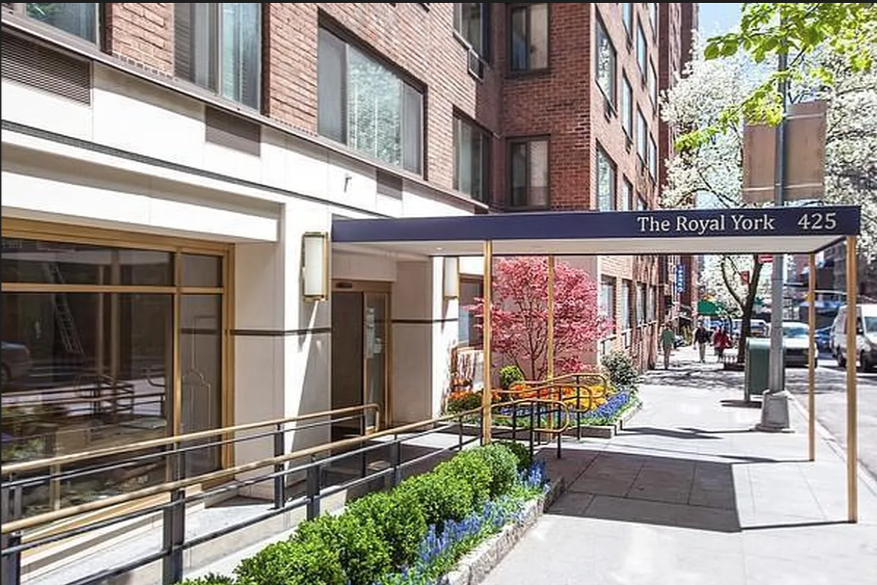 425 East 63rd Street, Unit E7A Manhattan, NY 10065 - Photo 12 of 13 a front view of a building with a glass door and glass windows