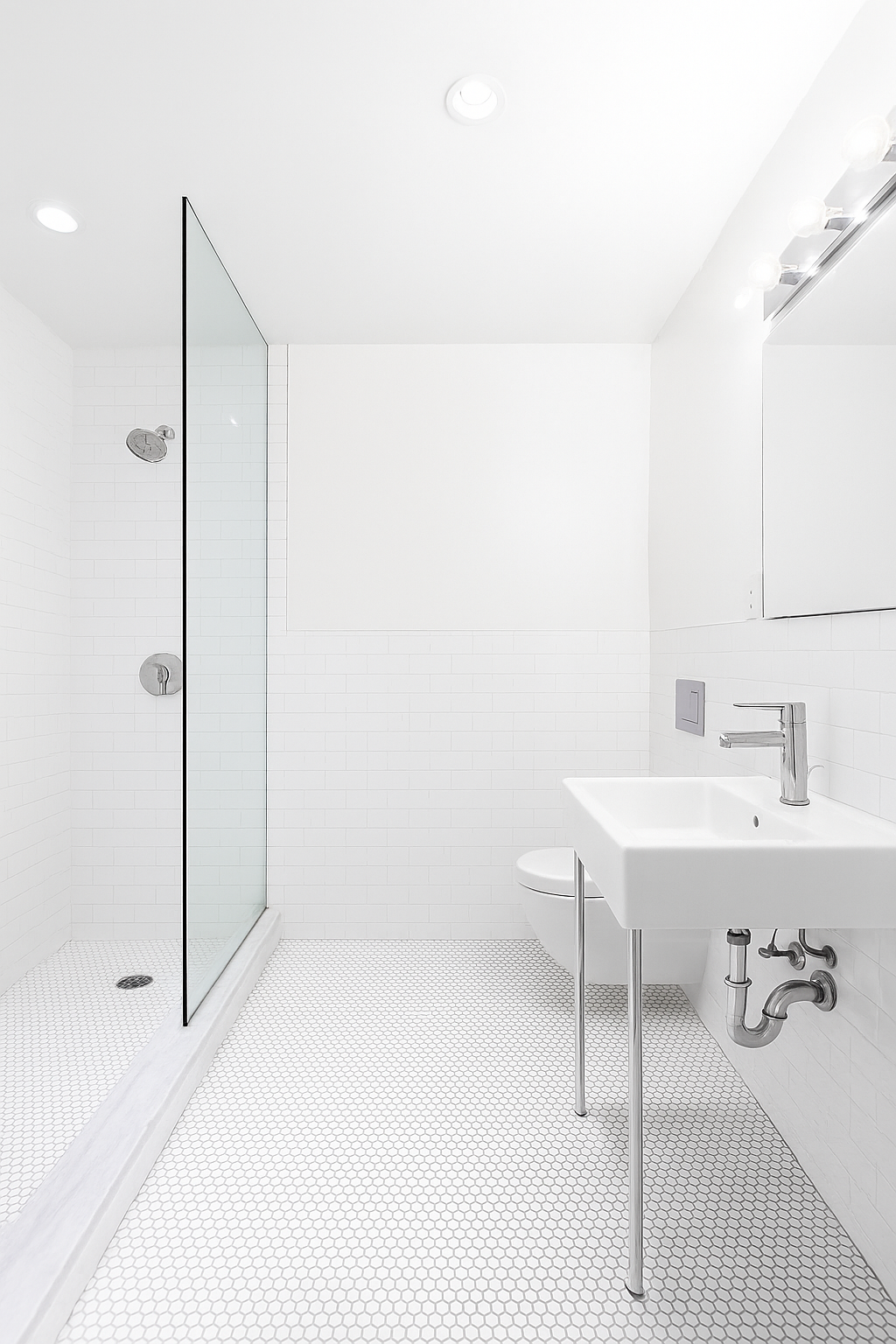 99 Avenue B, Unit 1B Manhattan, NY 10009 - Photo 5 of 8 a bathroom with a sink a toilet and shower