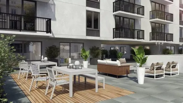 a view of a patio with couches table and chairs and potted plants