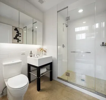 a bathroom with a sink toilet and shower