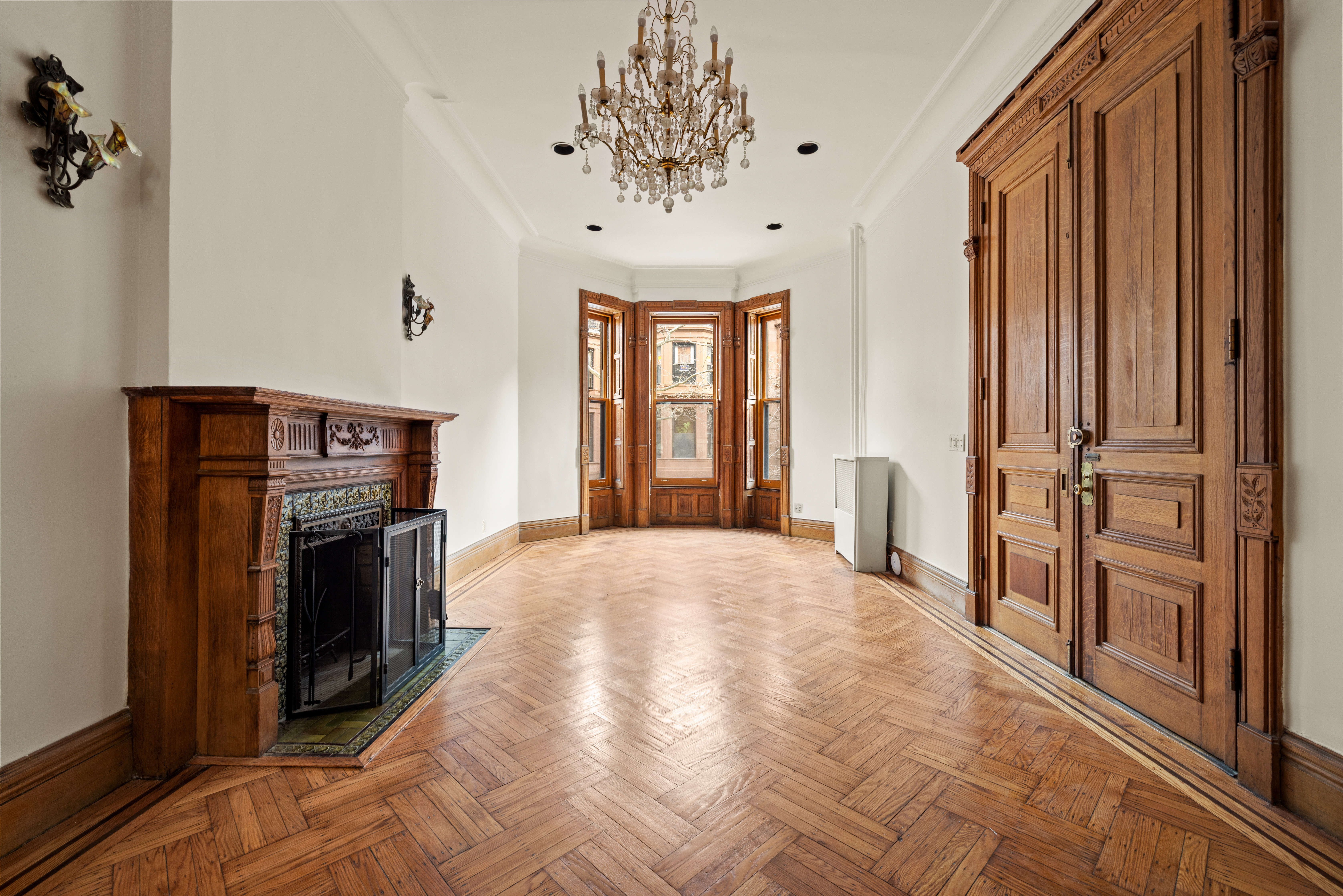a view of an empty room with a fireplace and a window