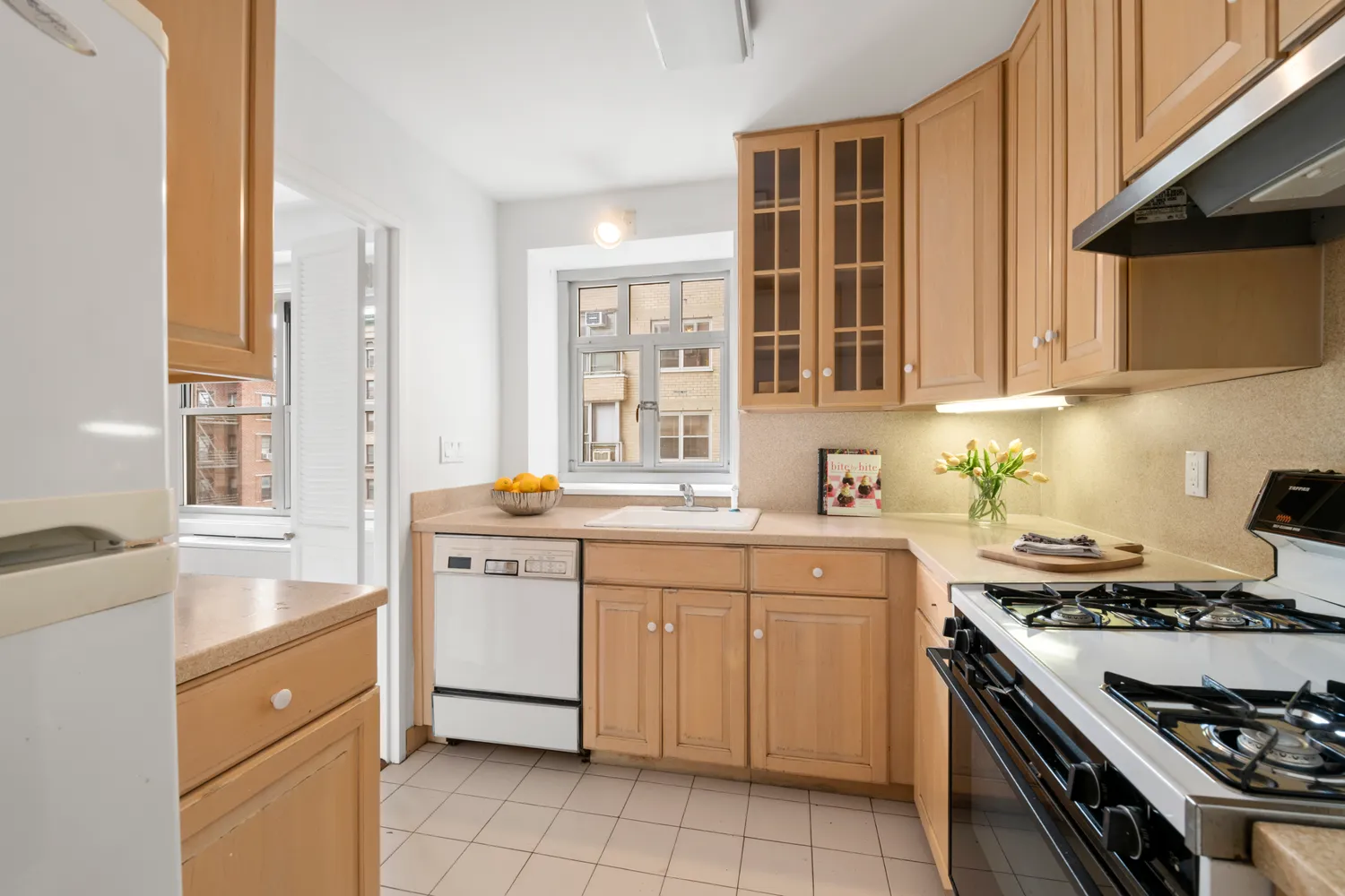 a kitchen with a stove sink and cabinets