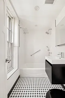 a bathroom with a bathtub and a shower
