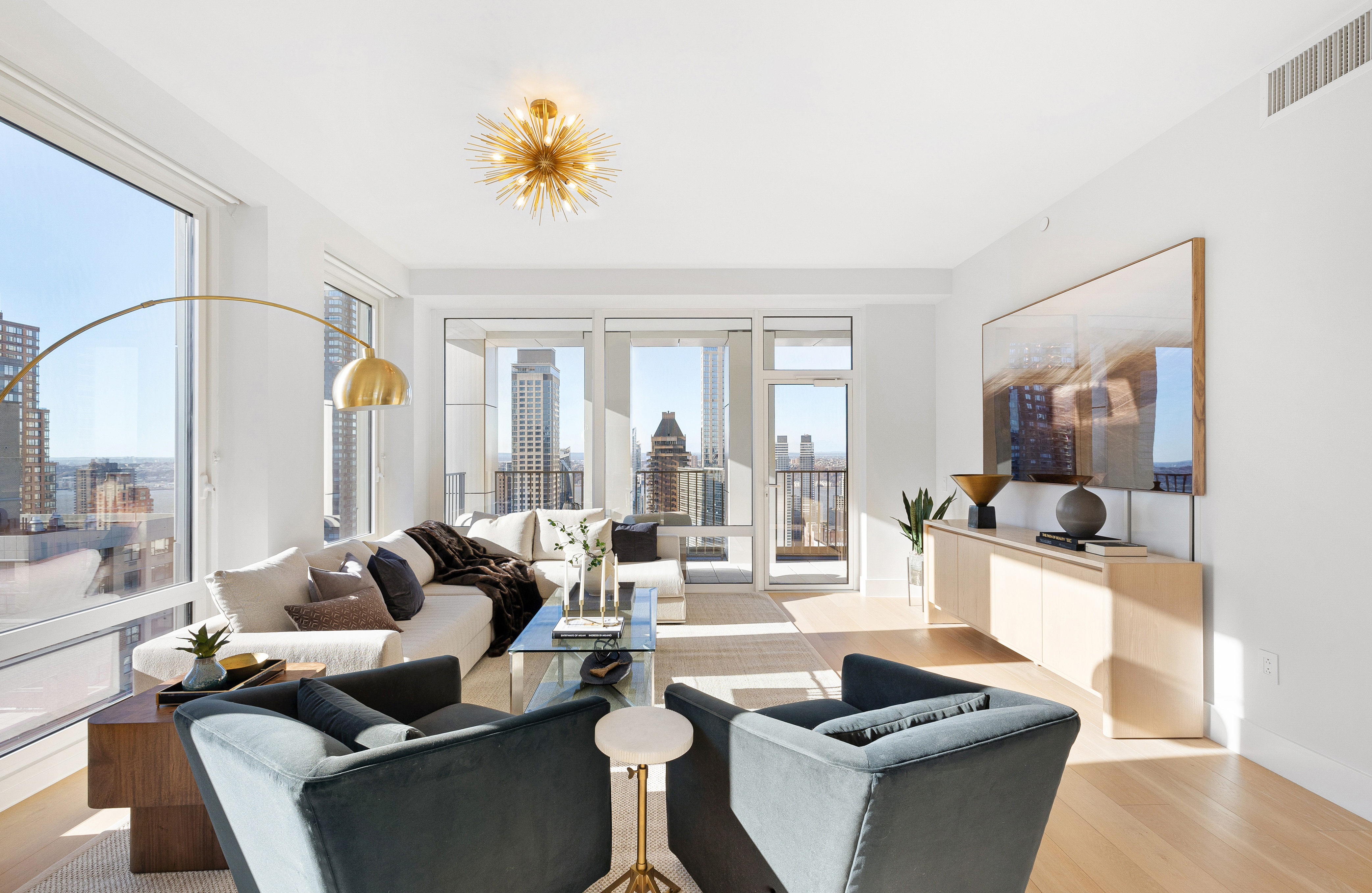 15 West 61st Street, Unit PH1C Manhattan, NY 10023 - Photo 4 of 26 a living room with furniture and a large window