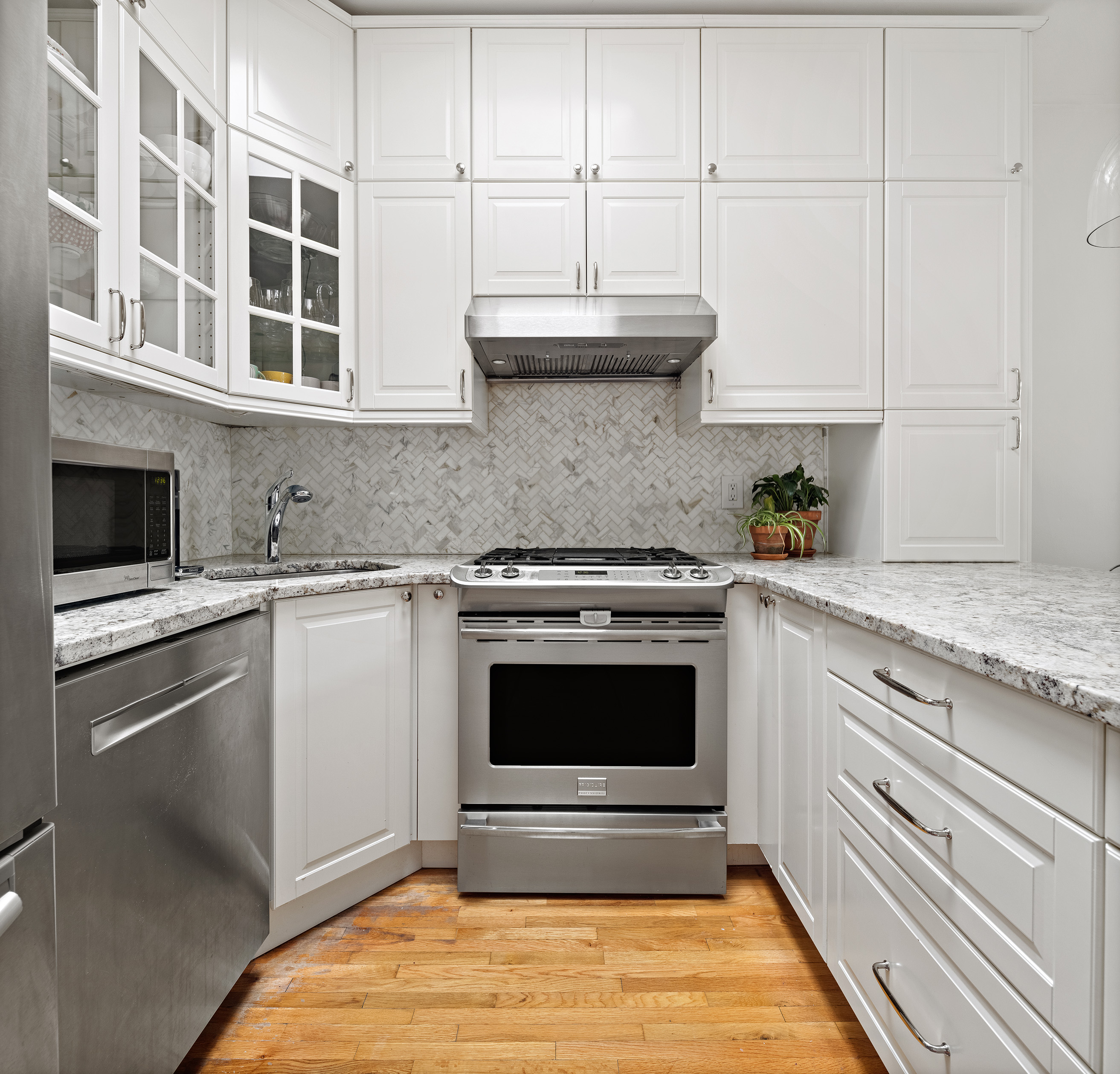 454 12th Street, Unit 3 Brooklyn, NY 11215 - Photo 5 of 18 a kitchen with stainless steel appliances granite countertop a stove and a white cabinets