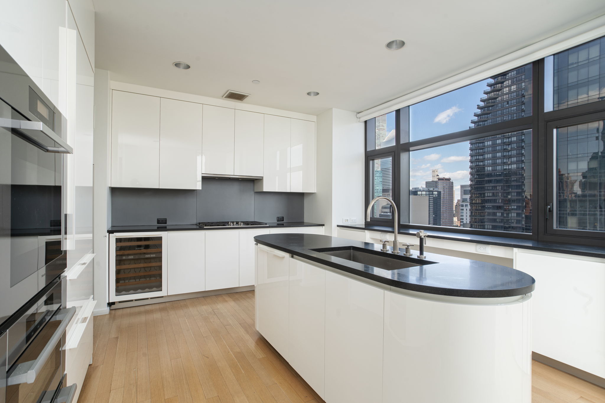 50 United Nations Plaza, Unit 26B Manhattan, NY 10017 - Photo 11 of 25 a kitchen with granite countertop a sink and a stove top oven
