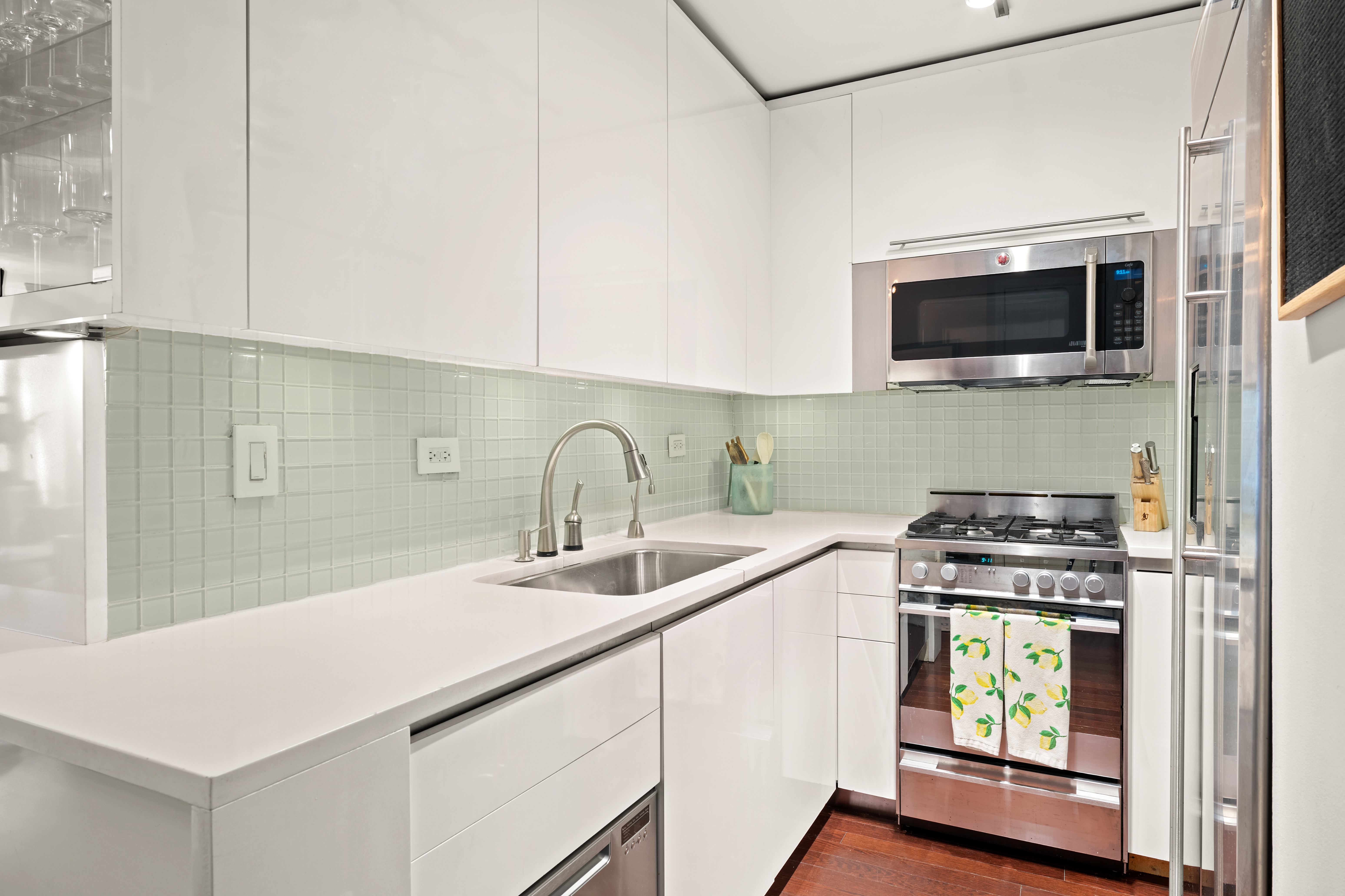 200 East 24th Street, Unit 1807 Manhattan, NY 10010 - Photo 4 of 10 a kitchen with a sink stove and microwave