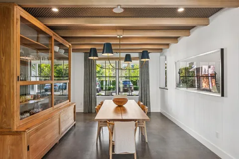 a kitchen with stainless steel appliances granite countertop a stove and a large window
