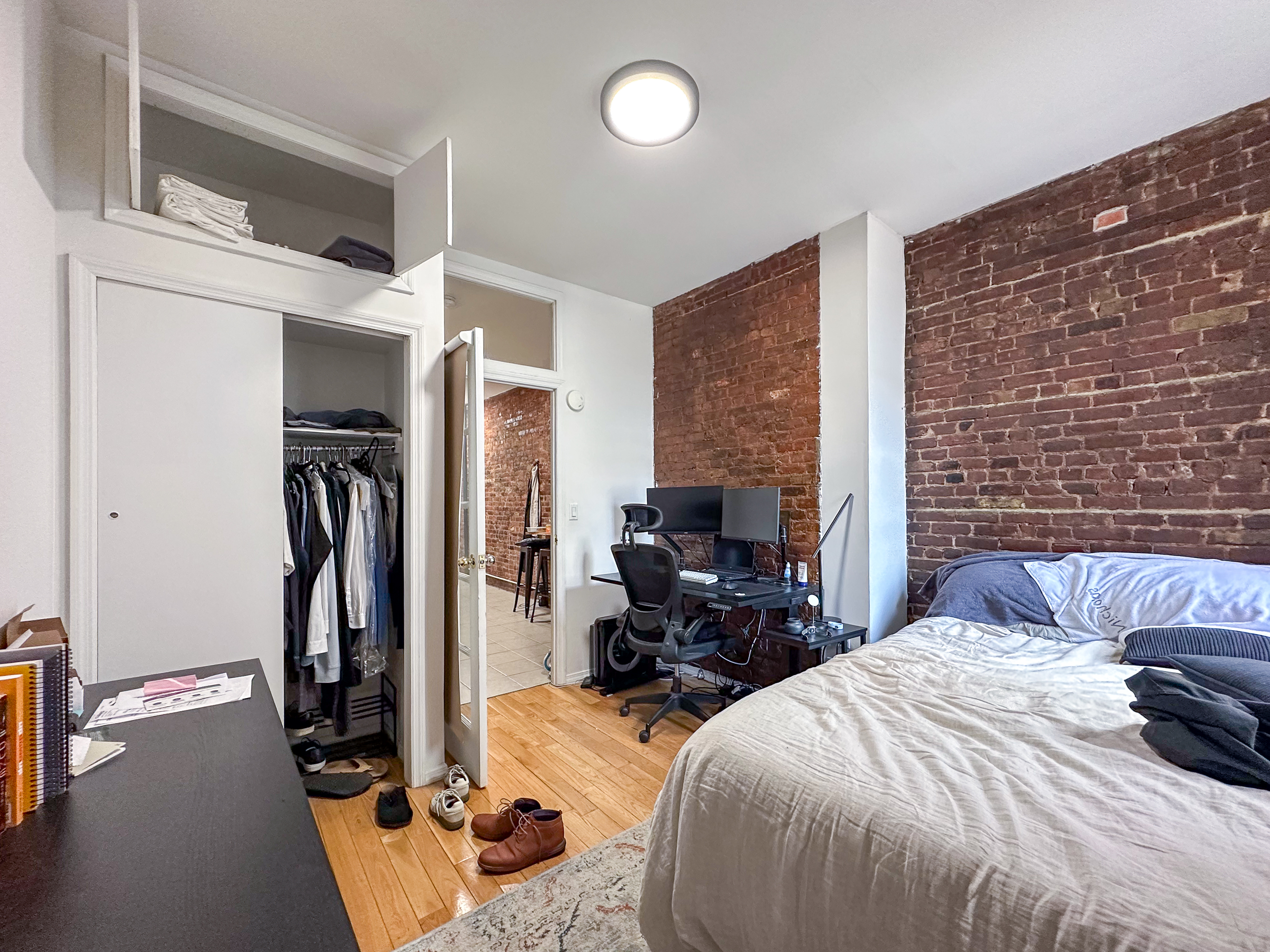 213 East 5th Street, Unit 5 Manhattan, NY 10003 - Photo 10 of 17 a bedroom with a bed and a flat tv screen on the dresser