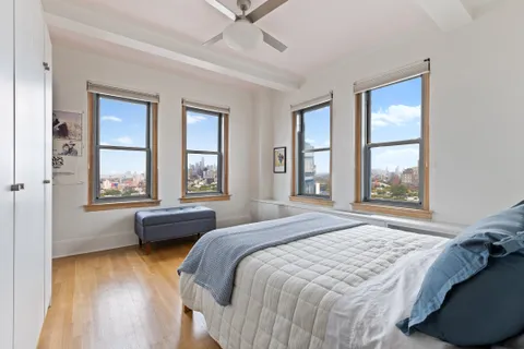 a bedroom with a bed and a large window
