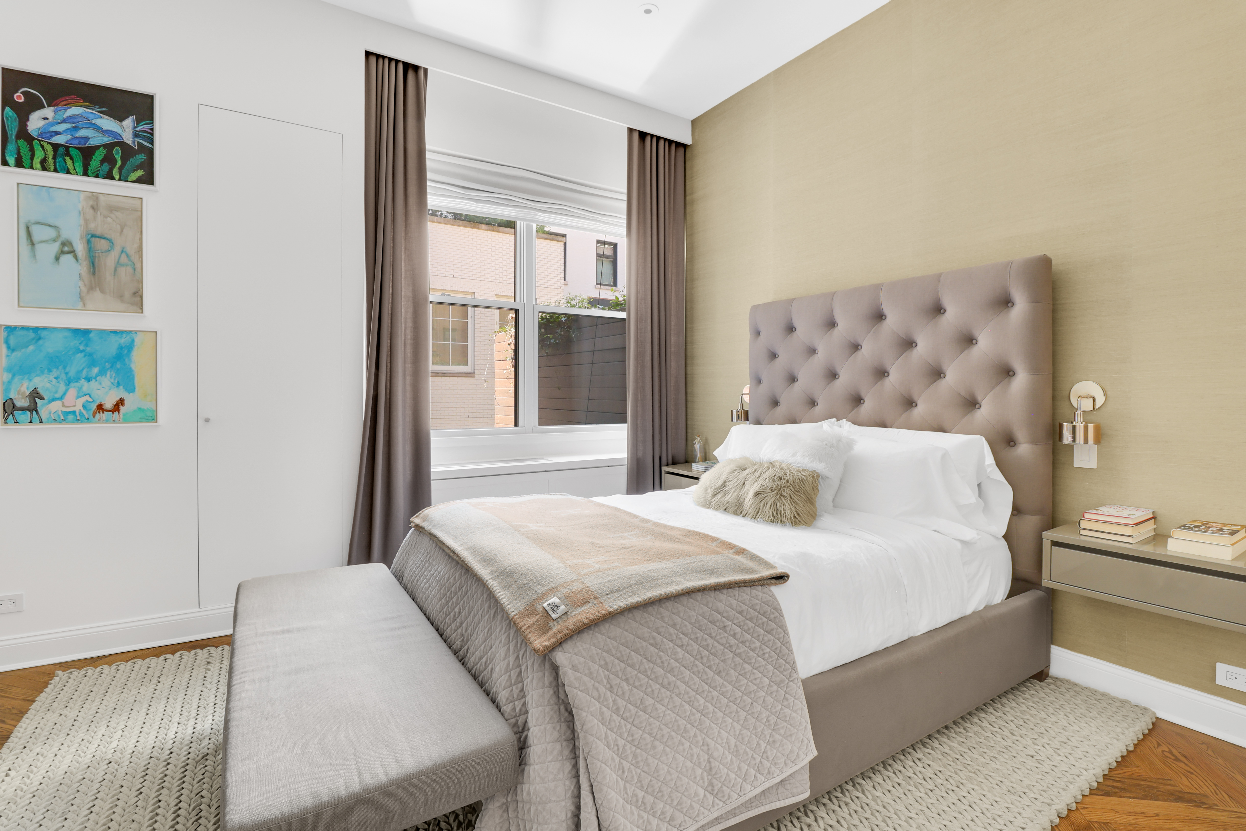 14 East 68th Street, Unit 3 Manhattan, NY 10065 - Photo 9 of 16 a bedroom with a large bed and a couch