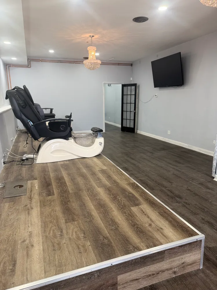 a room with stainless steel appliances wooden floor and view living room