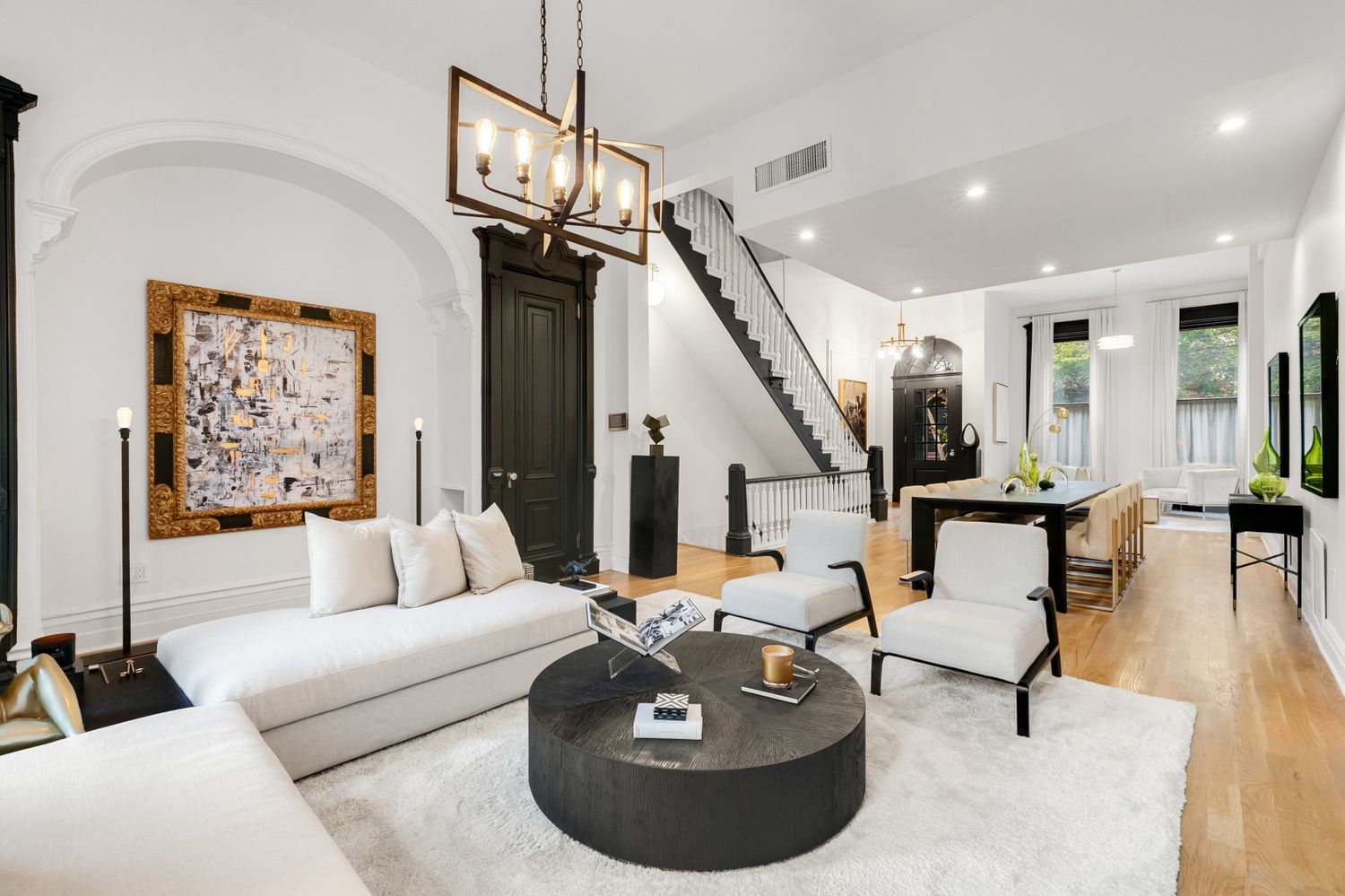 209 East 61st Street Manhattan, NY 10065 - Photo 2 of 27 a living room with furniture and a chandelier