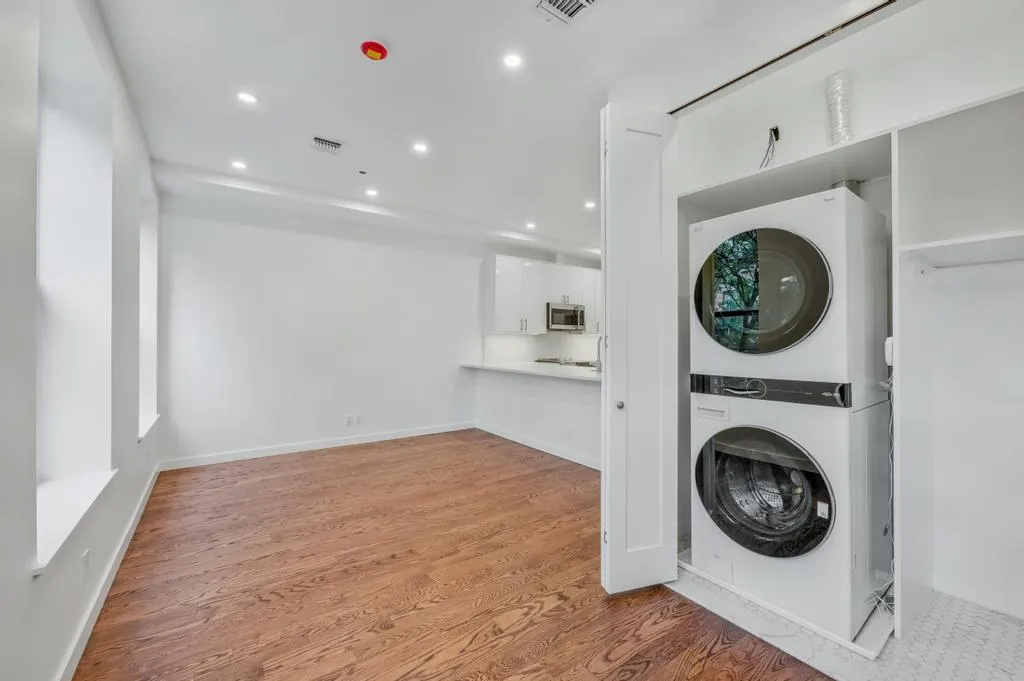 a view of a hallway with washer and dryer
