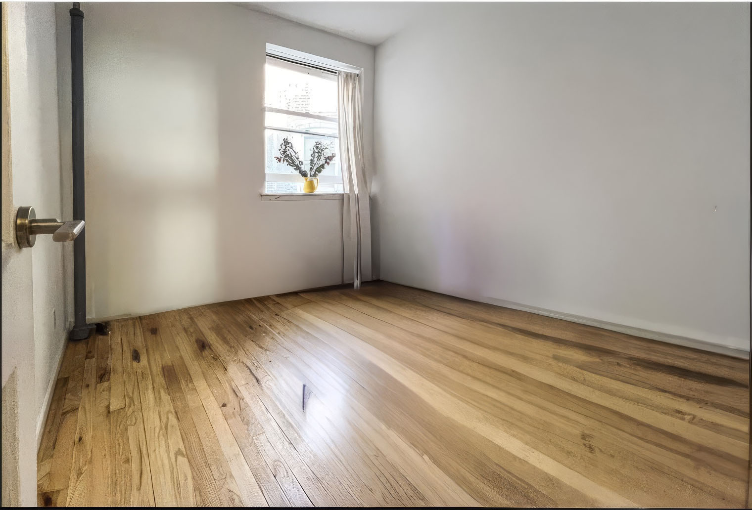 335 West 21st Street, Unit 4FE Manhattan, NY 10011 - Photo 4 of 11 an empty room with wooden floor closet and windows